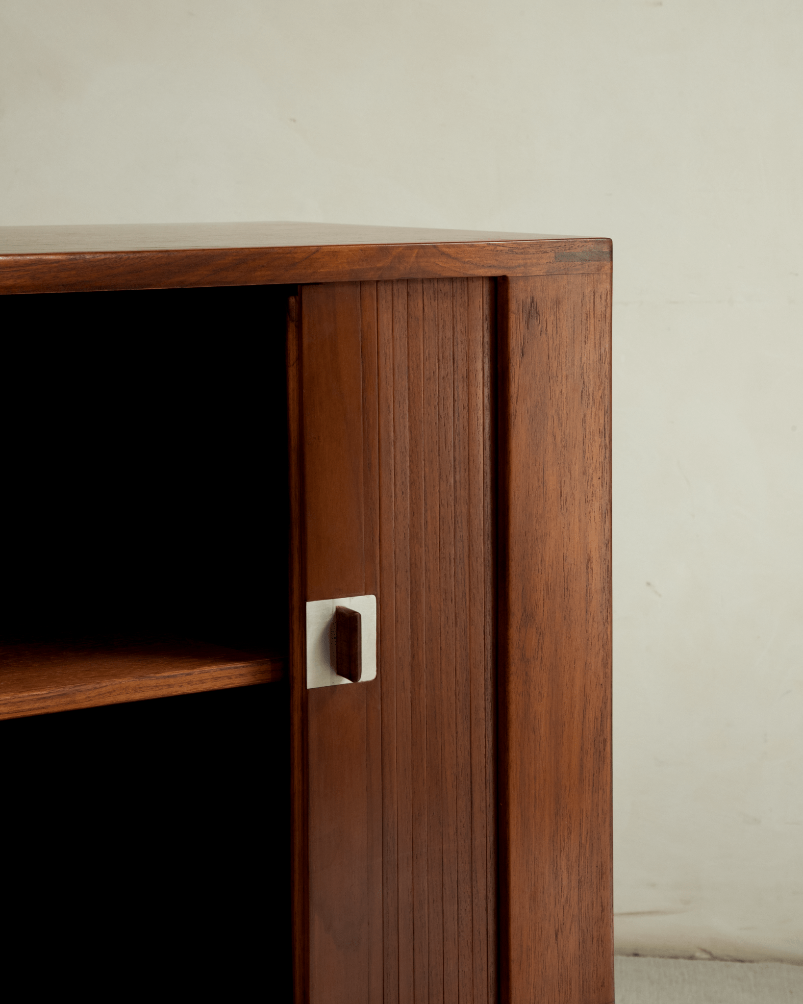 Martin Credenza solid teak storage cabinet with slatted roller shutter door and brushed metal handle.