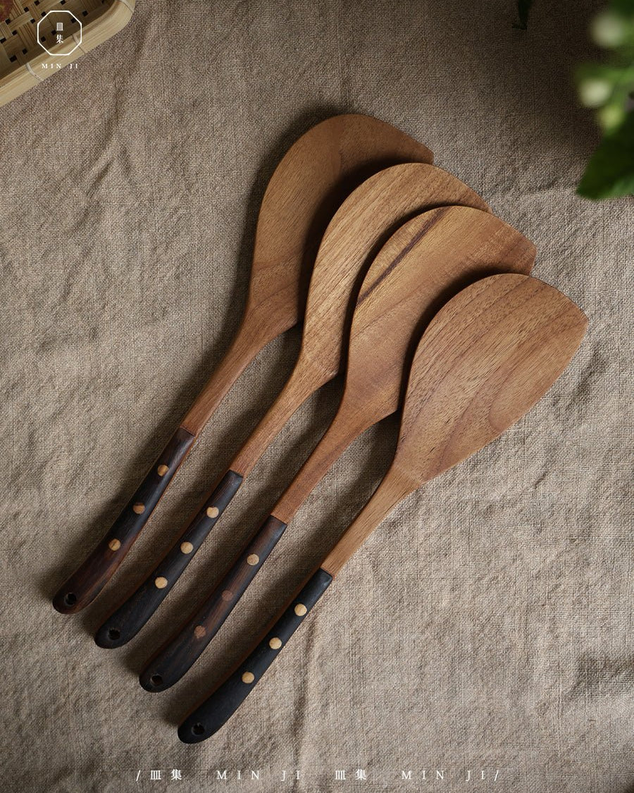 MIN JI teak wood fried spatulas with dark studded handles for cooking.
