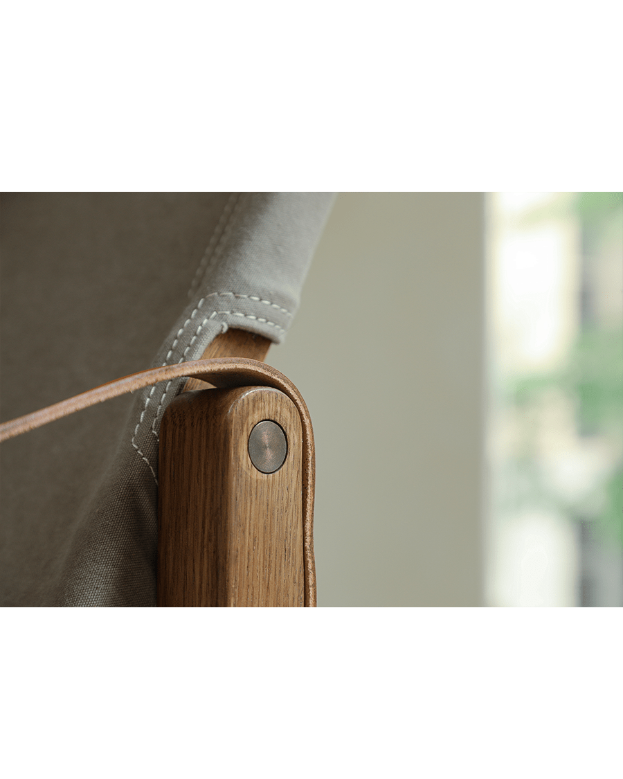 Safari Chair detail: Brass hardware on US Red Oak frame, canvas backrest and leather strap - portable design
