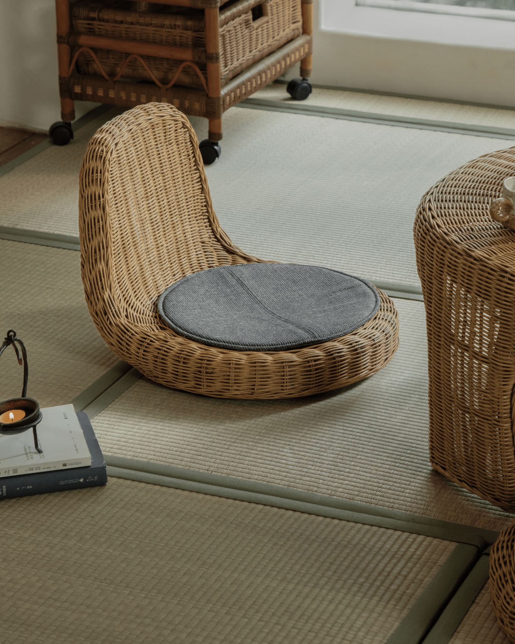 Lotus Tatami Set - Rattan chair with gray cushion on tatami mat, creating a zen tea room ambiance.