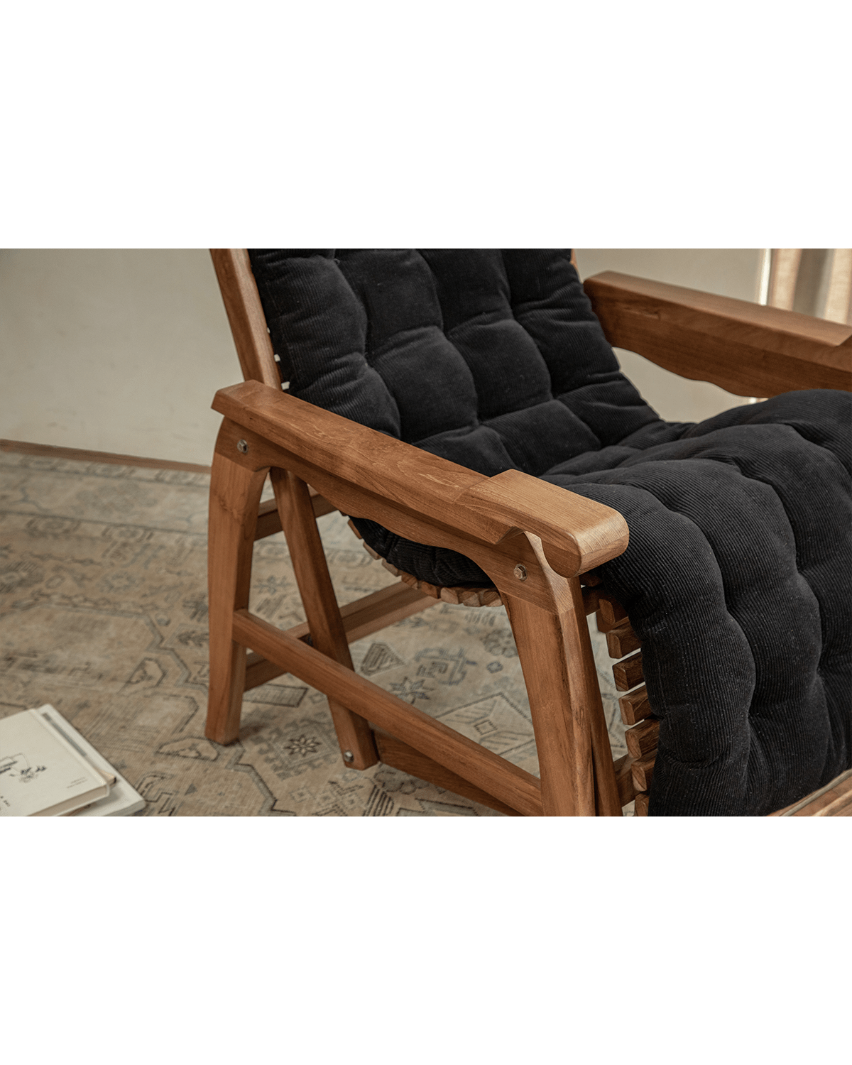 Teak Roller Chaise Lounge Chair with black corduroy cushion; ideal for indoor relaxation and full-body support.