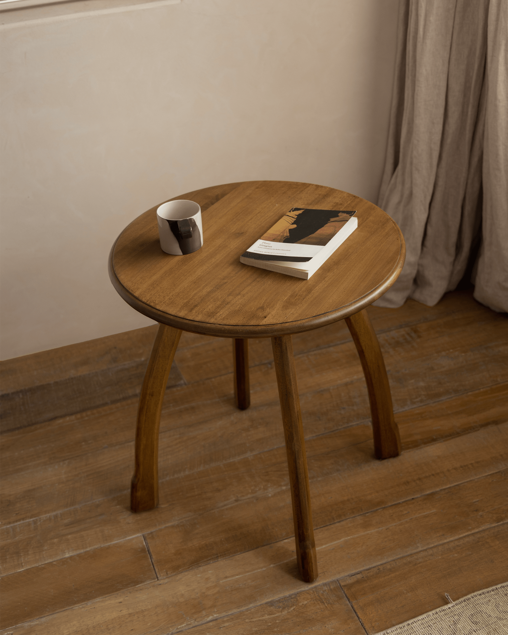 Ele Round Side Table in Phoebe wood with book, vintage finish, compact design