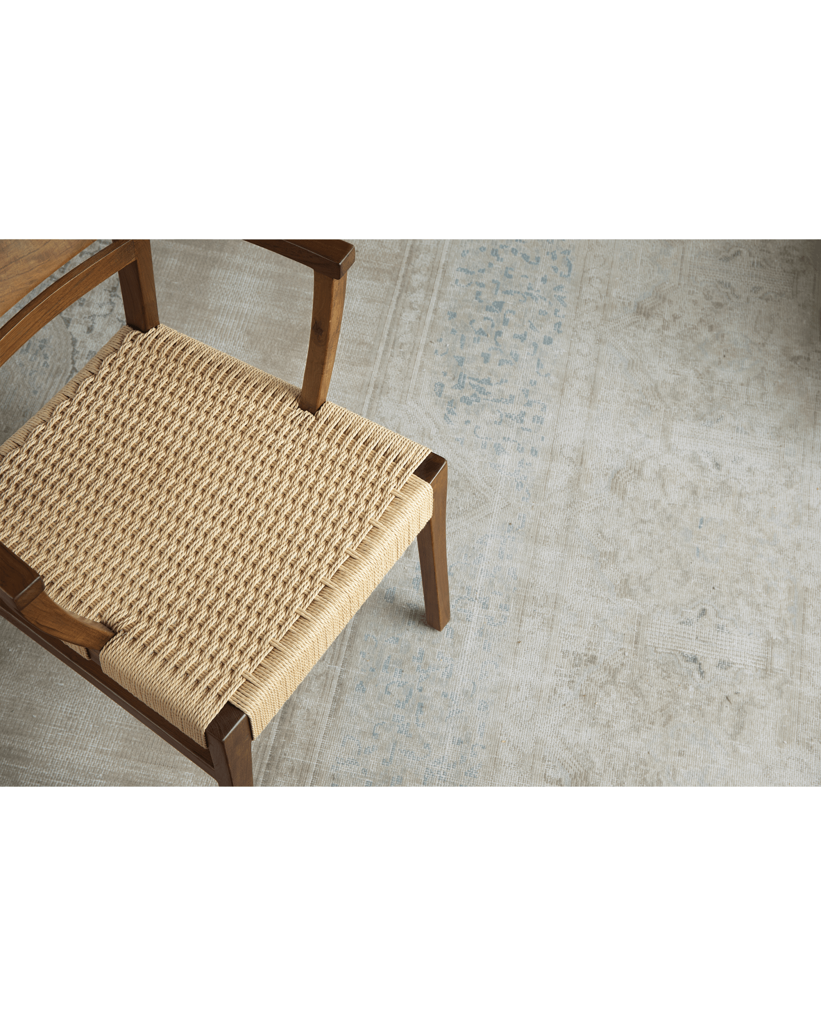 Hug Chair detail: woven seat and wooden frame, modern design, natural tones and texture