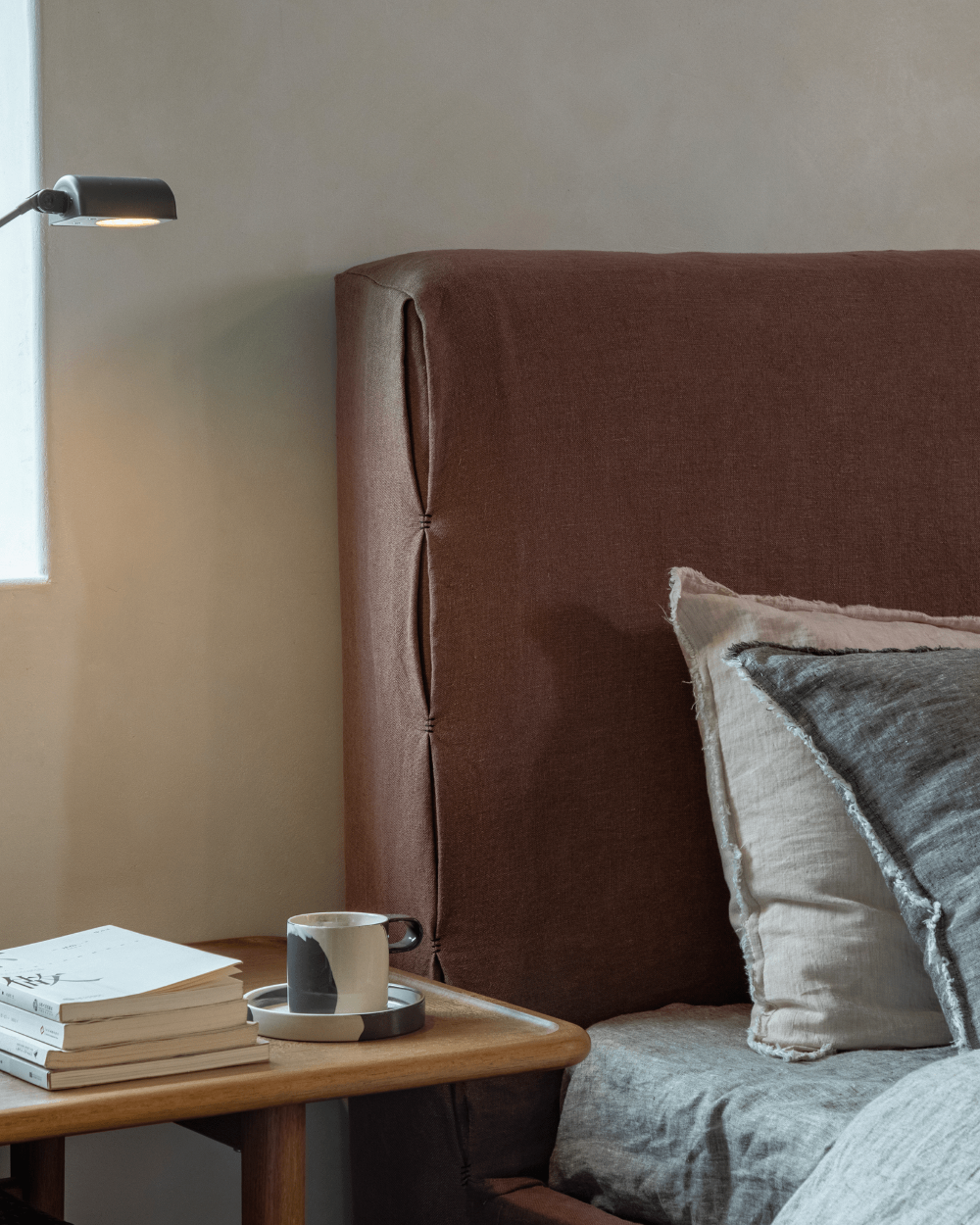 Freya Linen Bed in terracotta linen with headboard detail, minimalist bedroom decor for peaceful sleep