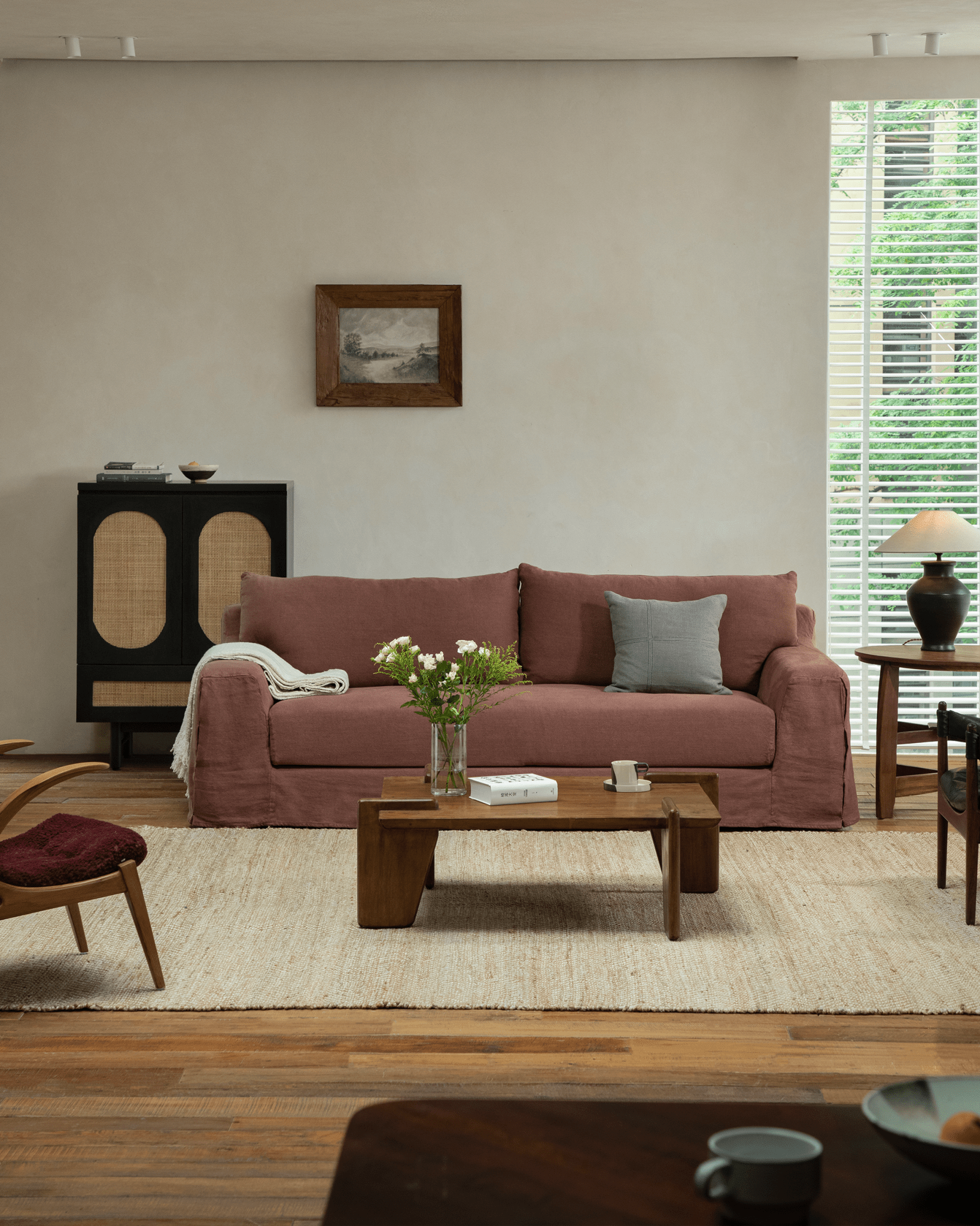Terracotta Guni Linen Sofa in a cozy living room setting, featuring linen fabric, wooden furniture, and a natural rug
