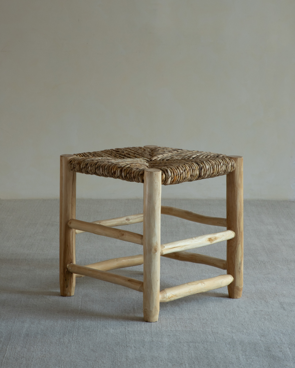 Isla Handwoven Stool, natural teak frame with woven pandan leaf seat. Modern, organic design, artisan-made.