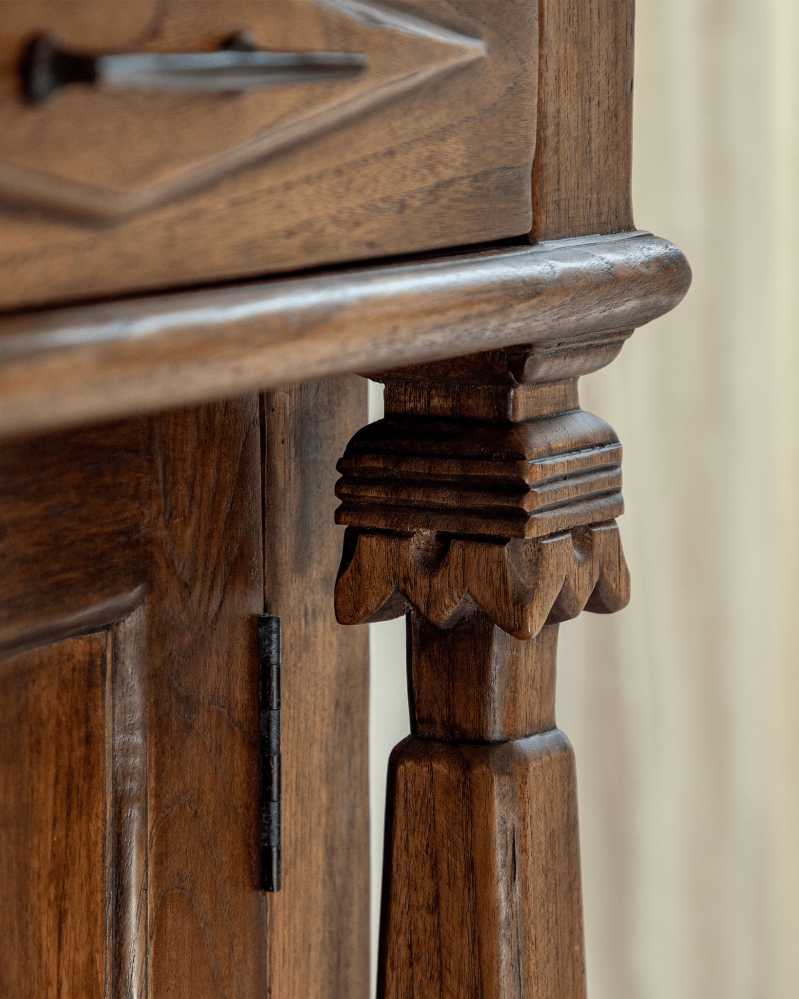 Antique teak cabinet detail with carved Roman column leg.
