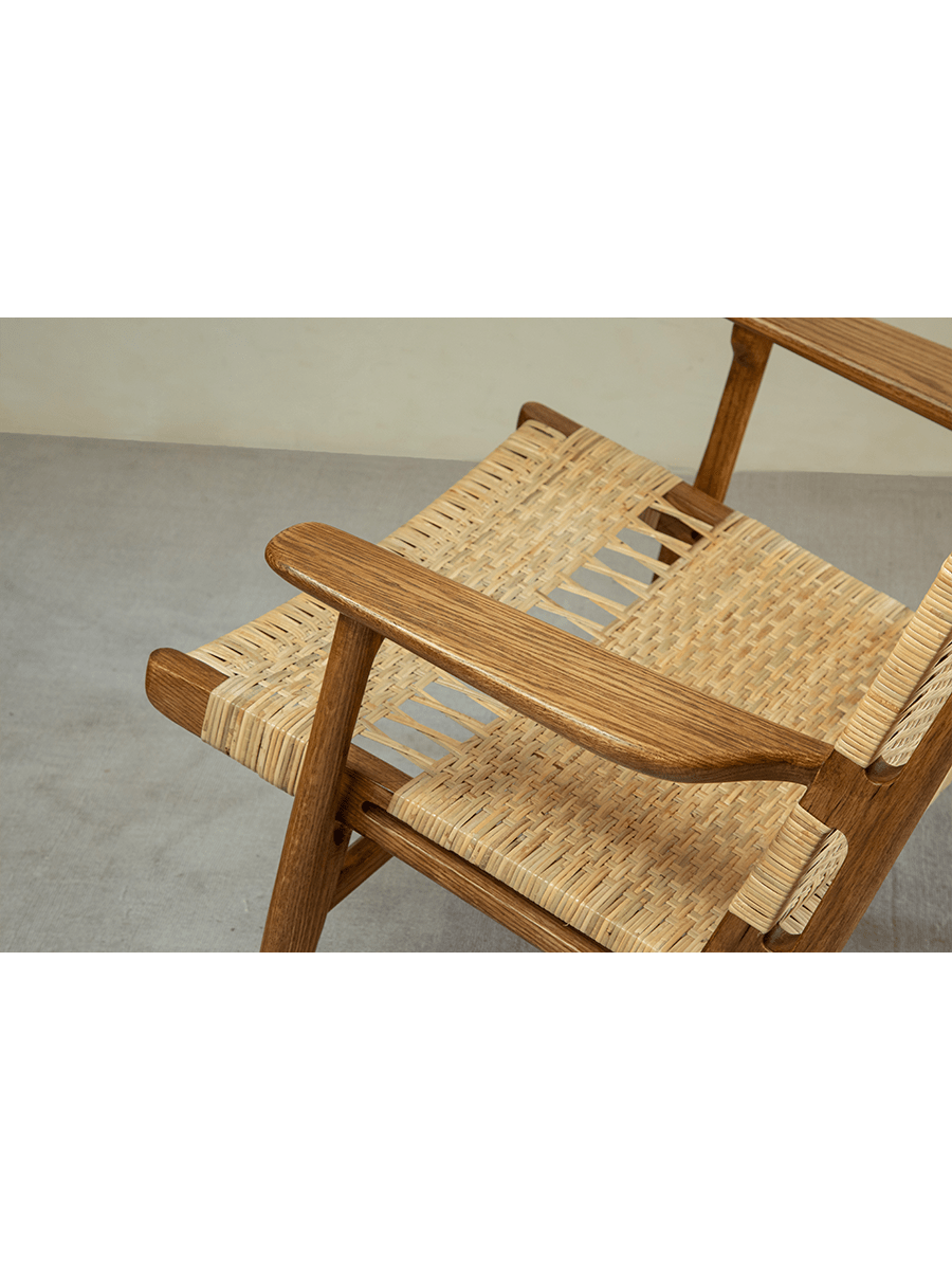 Horn Lounge Chair detail: natural rattan seat and oak frame, ergonomic design, handcrafted for comfort