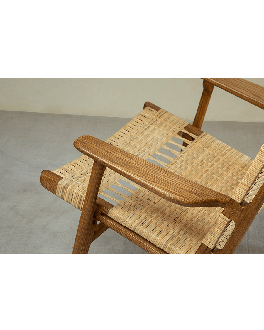 Horn Lounge Chair detail: natural rattan seat and oak frame, ergonomic design, handcrafted for comfort