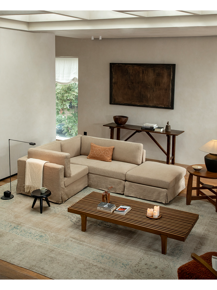 Beige linen skirt sectional sofa in modern living room with modular design and relaxed atmosphere