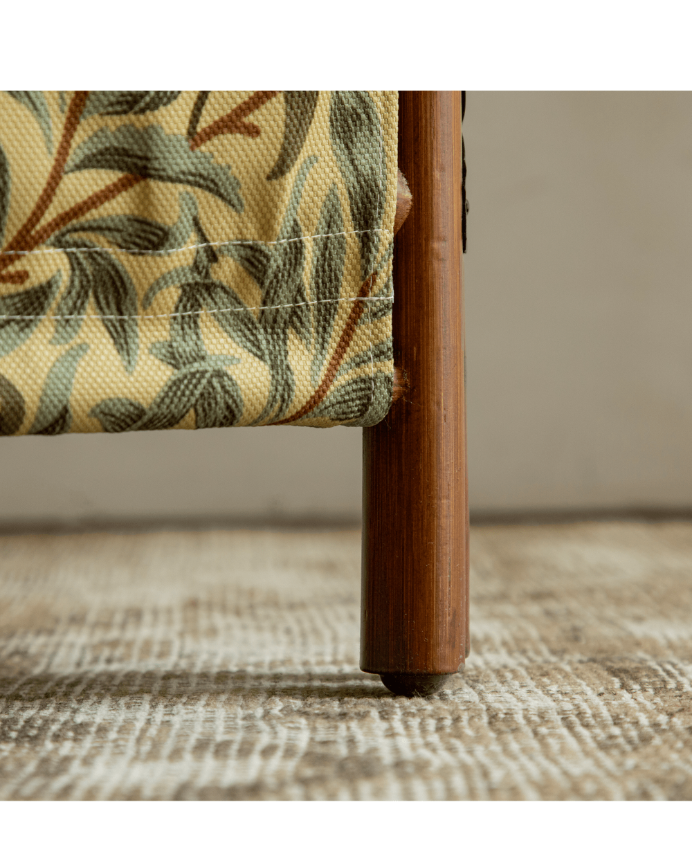 GeTan rattan room divider leg with detachable fabric showing willow leaf pattern.