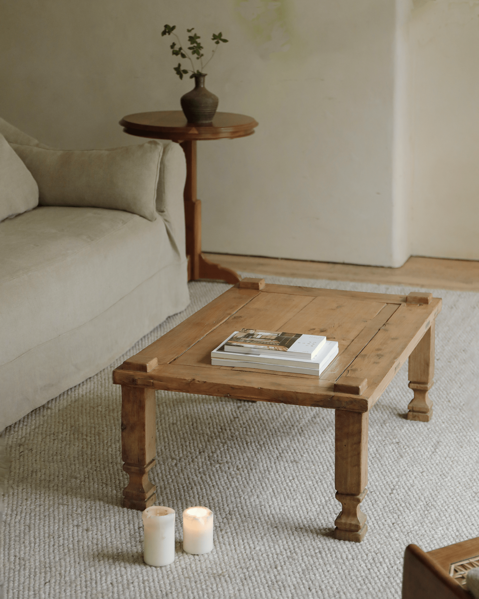 Keoni Coffee Table in a natural living room setting with candles, showcasing reclaimed wood and rustic design