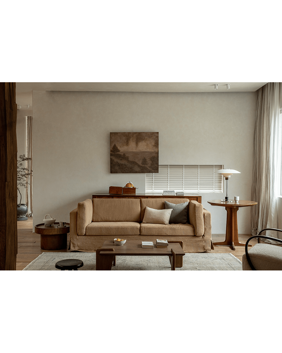 Tan Skirt Linen Sofa in a modern living room setting with wooden furniture and rug. Creating a peaceful atmosphere.