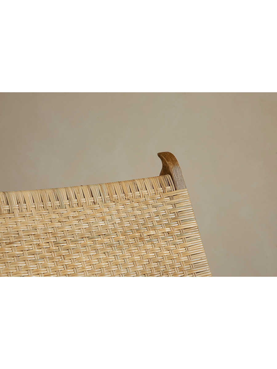 Horn Lounge Chair detail: natural rattan seat and oak frame, ergonomic design, handcrafted for comfort