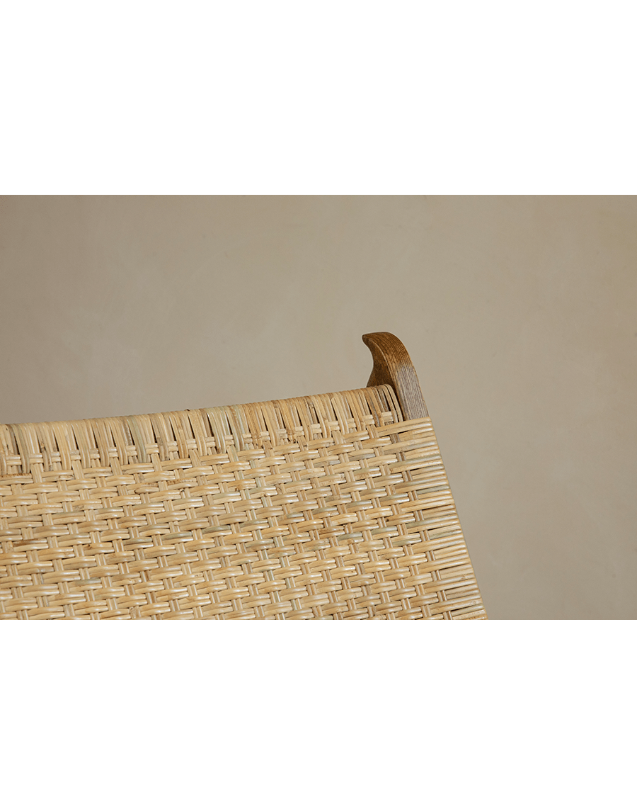Horn Lounge Chair detail: natural rattan seat and oak frame, ergonomic design, handcrafted for comfort