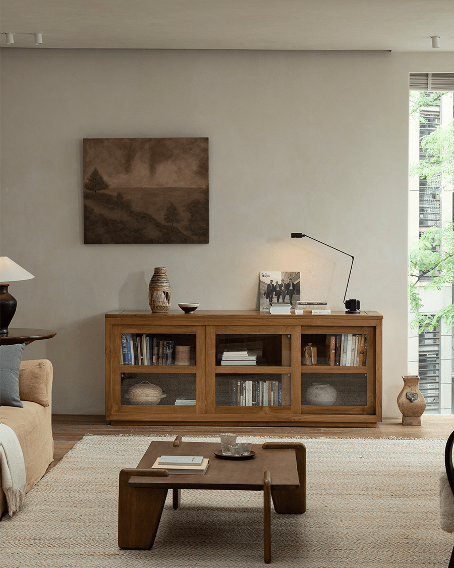 Teak wood glass front bookcase in a stylish living room setting