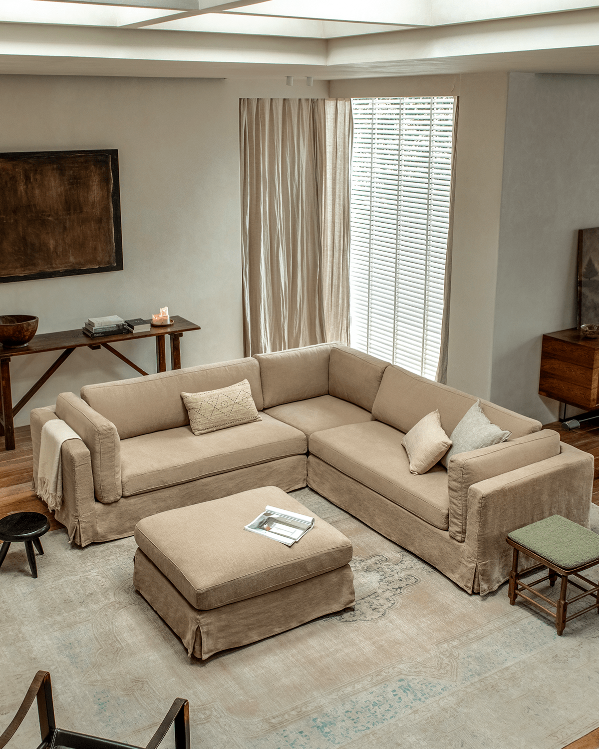 Beige linen Skirt Sectional Sofa in a modern living room, modular design, customizable comfort, relaxed atmosphere