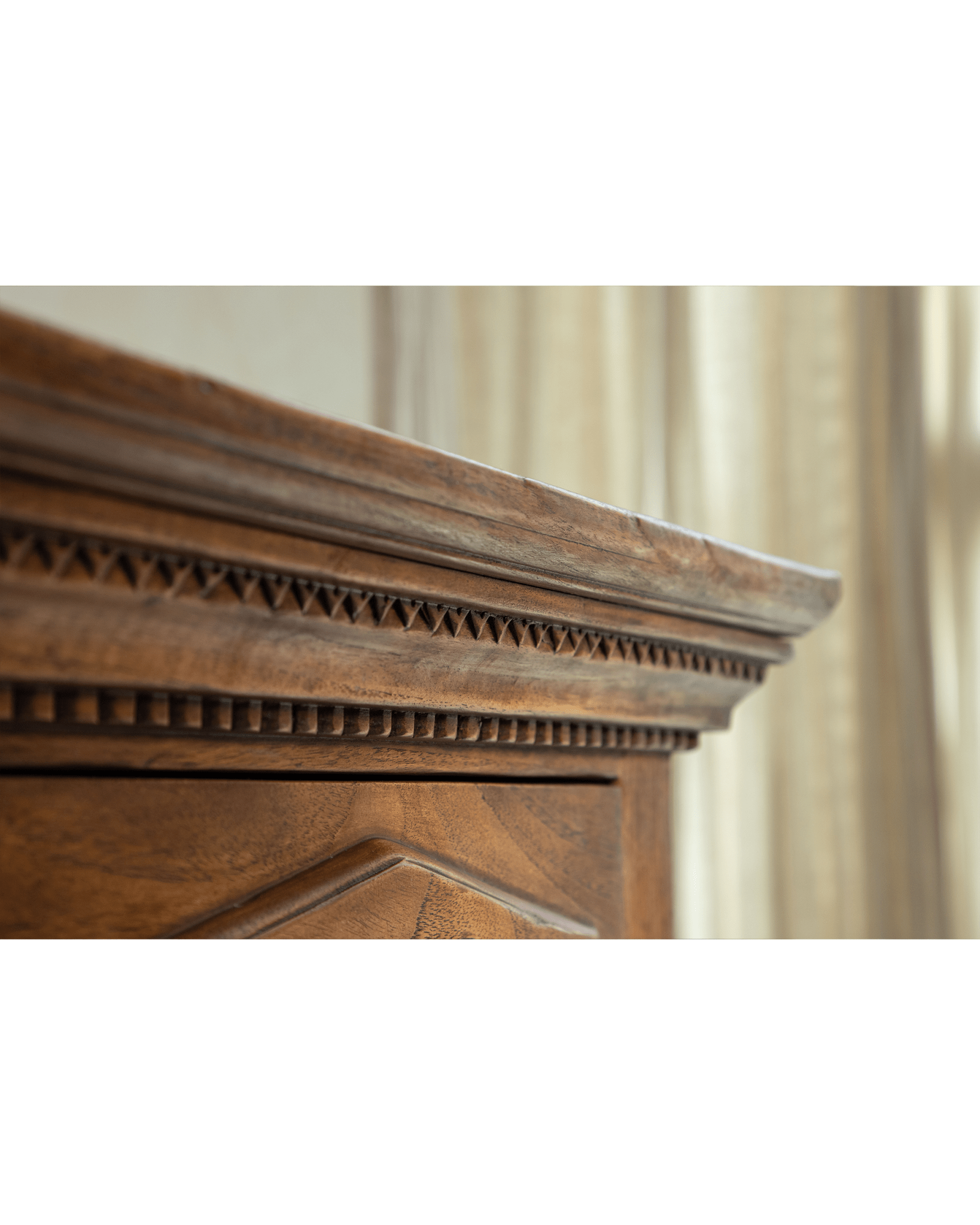 Victoria Teak Cabinet featuring antique finish and intricate carved molding.