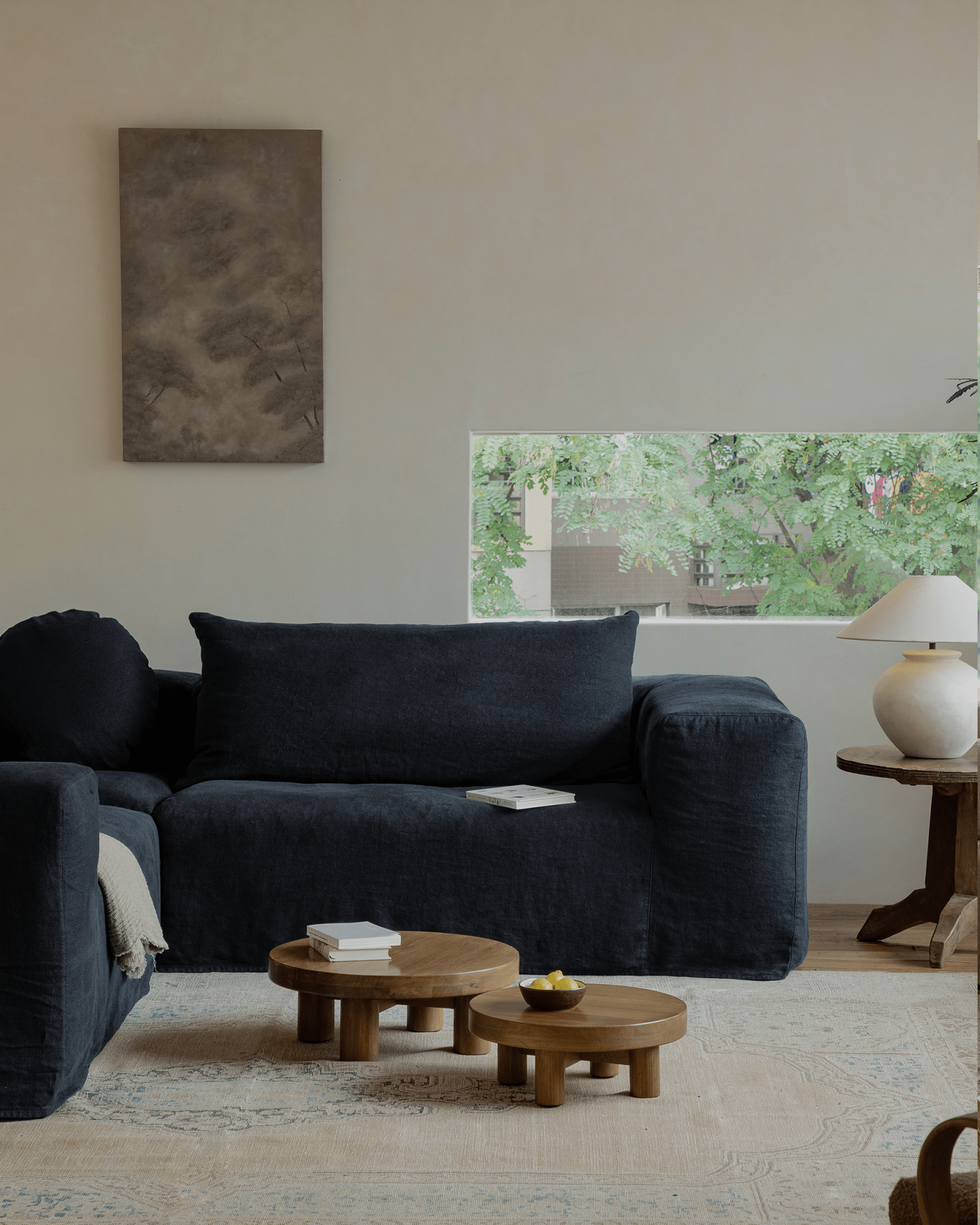 Doma sectional sofa in dark linen, a relaxed living space, modular design, with a bright, airy aesthetic.
