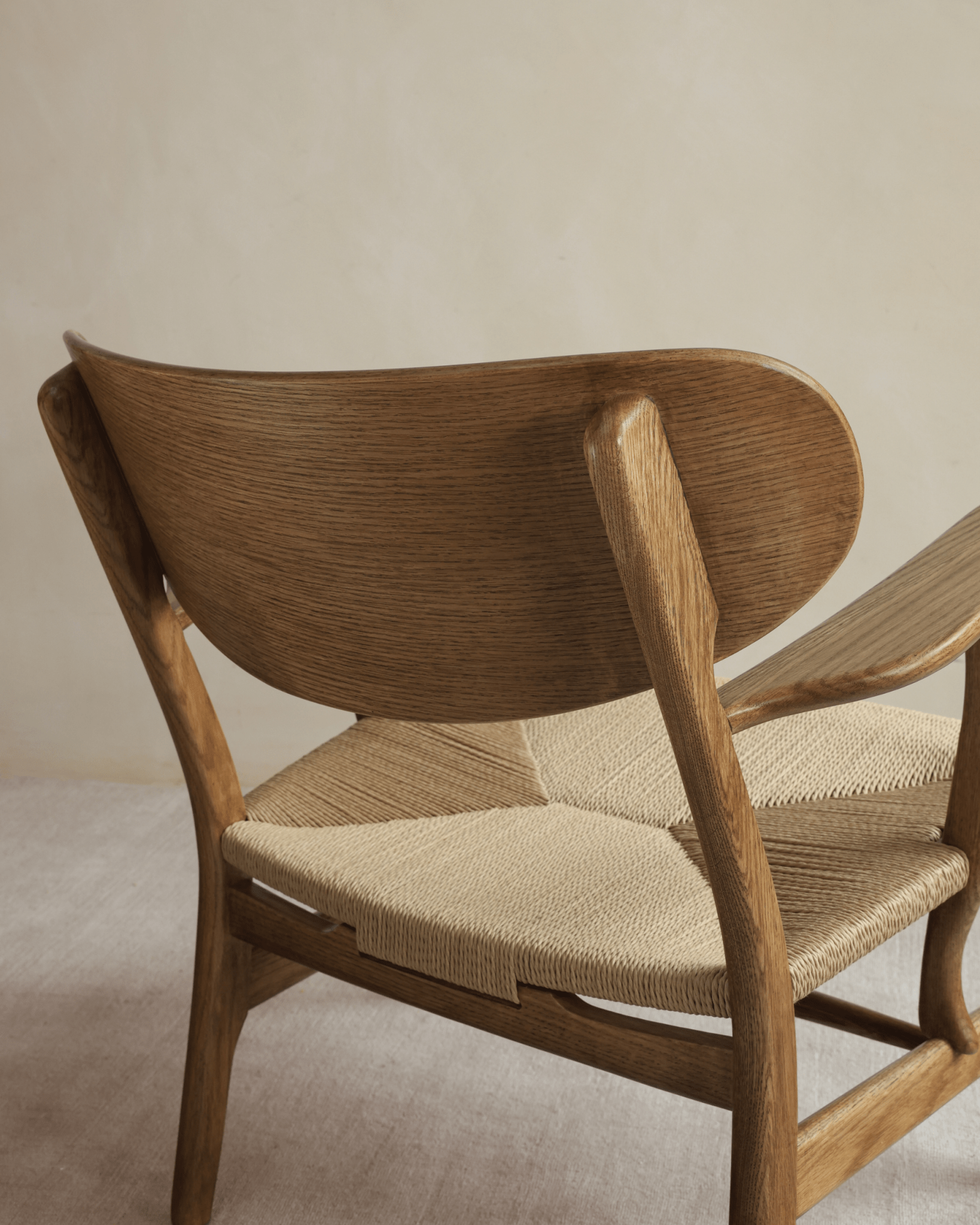 CH22 Lounge Chair: Oak frame and woven paper cord seat detail. Scandinavian design for modern interiors.