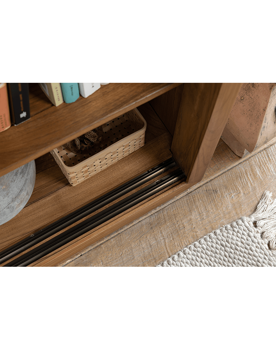 Teak wood Glass Front Bookcase sliding door track detail with natural wood grain and woven basket storage