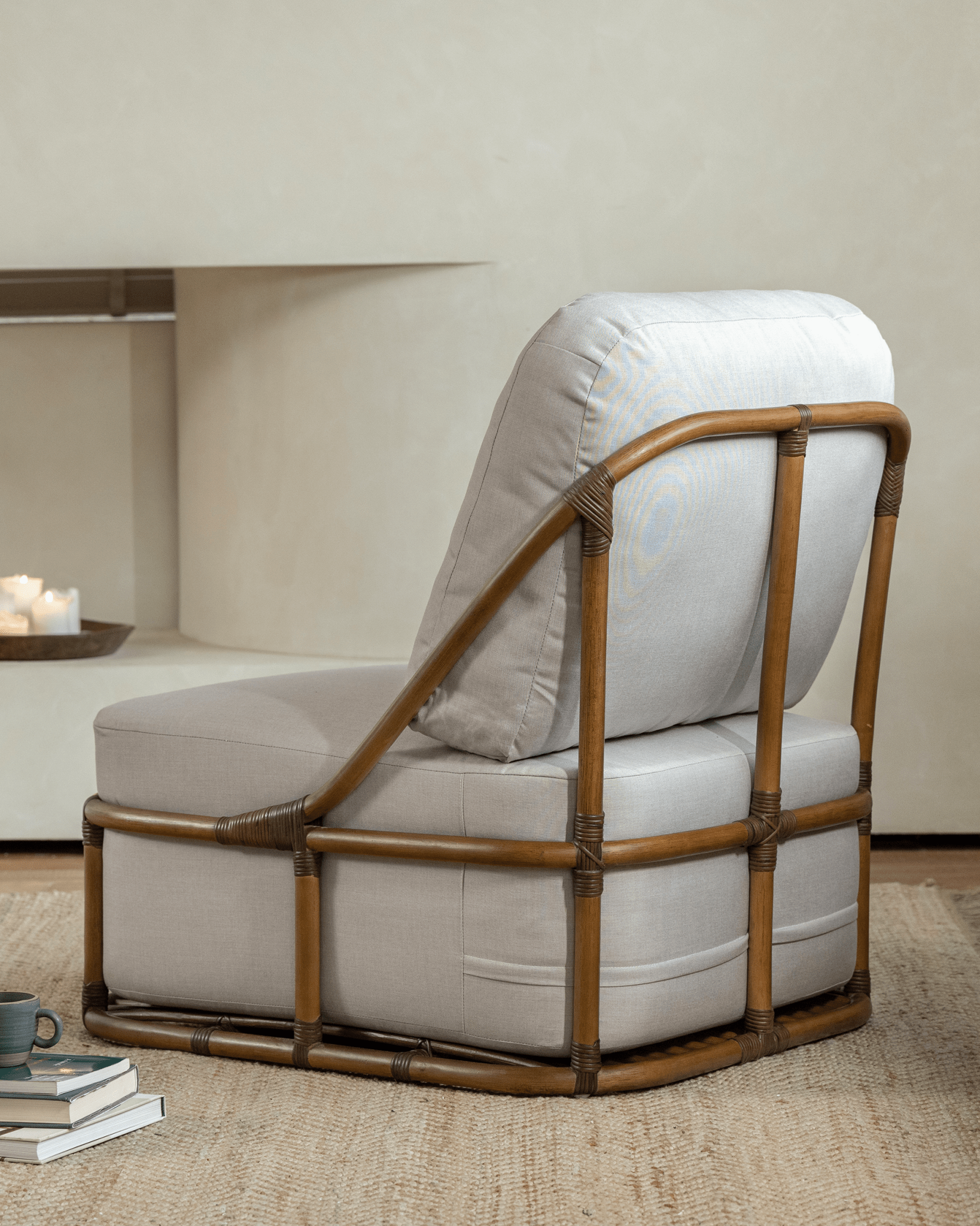 Tofu Lounge Sofa in a living room. Natural rattan frame with light gray cushion, promoting relaxed seating