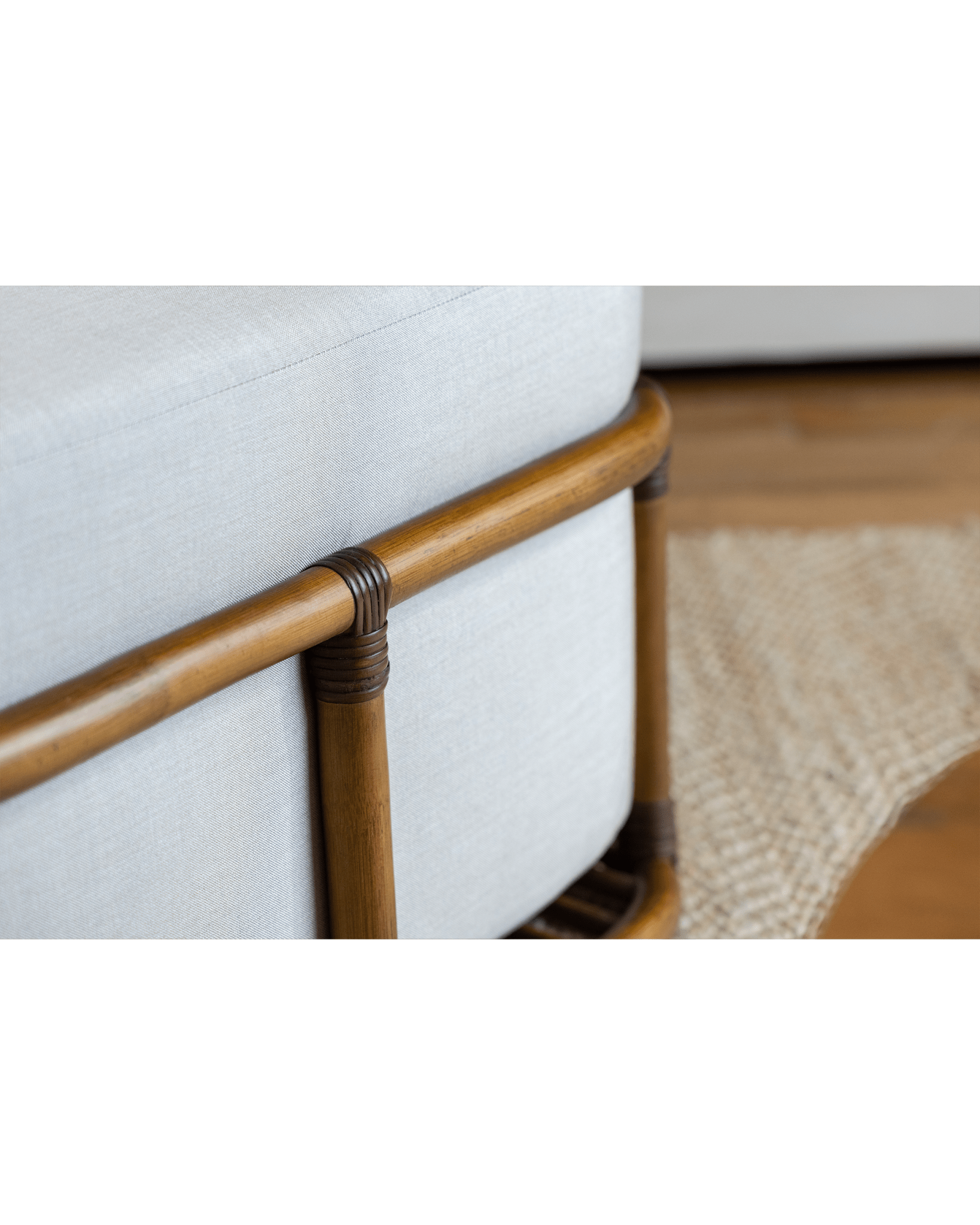 Tofu Lounge Sofa detail: Natural rattan frame, light gray cushion, promoting relaxed and comfortable seating