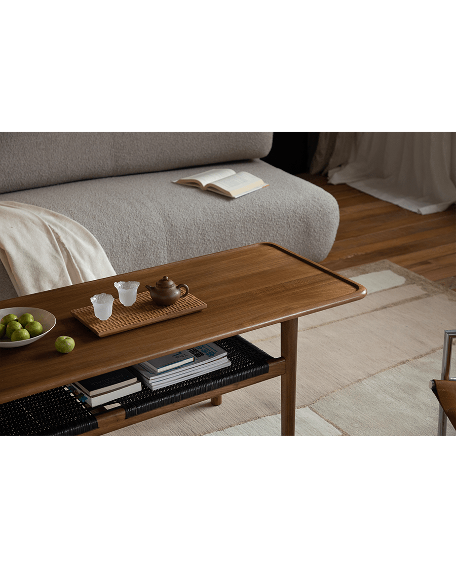 Hans Accent Table in a modern living room setting with tea set and woven shelf.