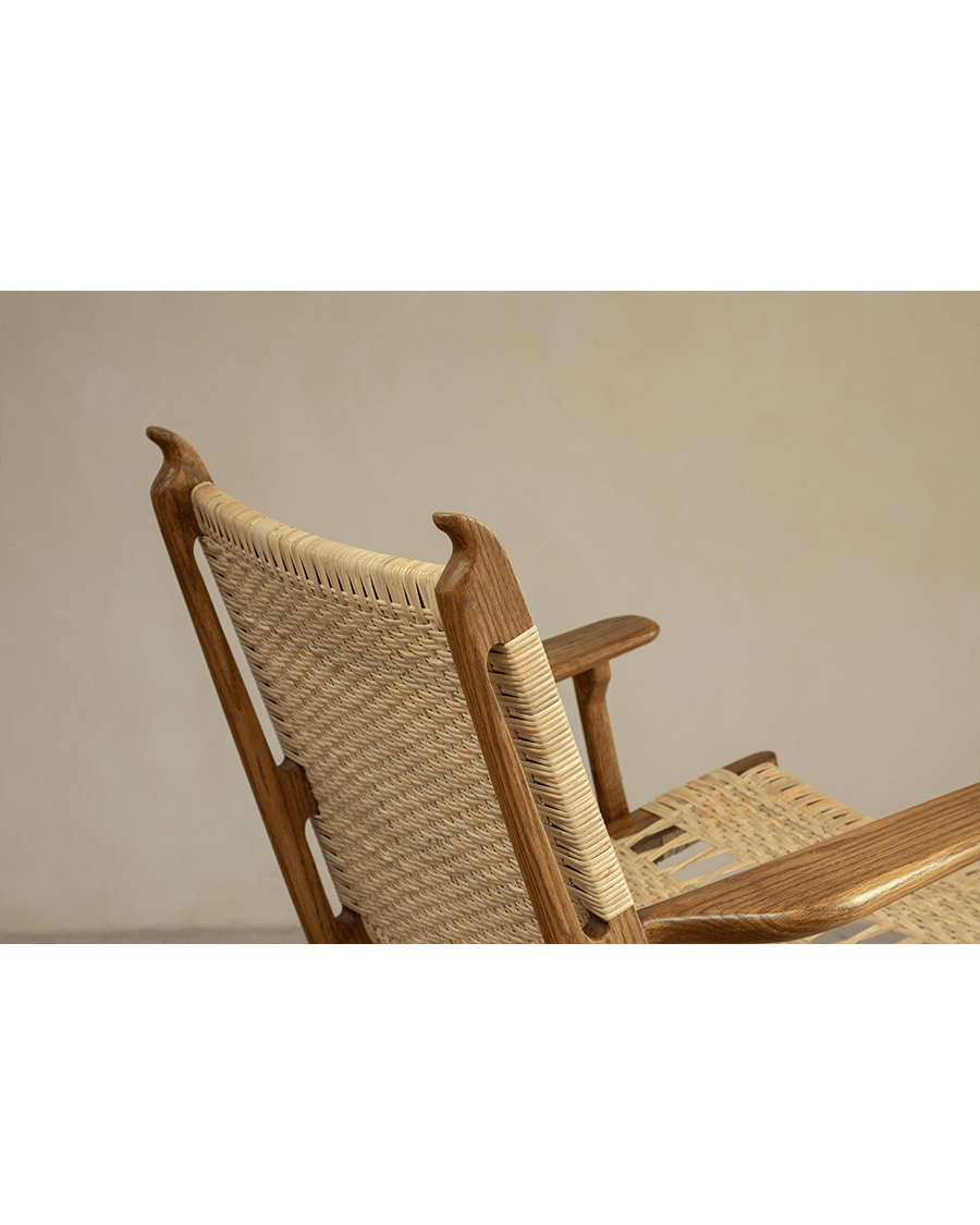 Horn Lounge Chair detail, natural rattan backrest and seat, oak frame, ergonomic design, handcrafted for comfort.