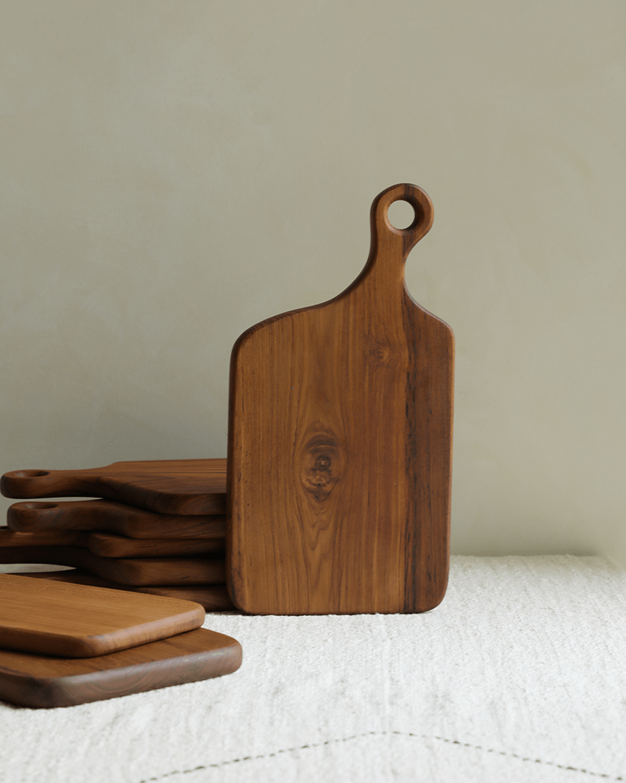 Teak wood cutting board with hanging hole, natural grain texture, multiple boards