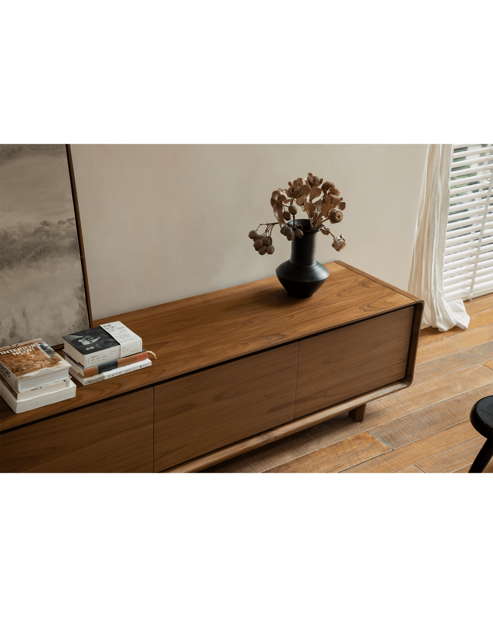 NO.34 Media Console in natural wood finish, with decor, books, and black vase. Modern living room setup.