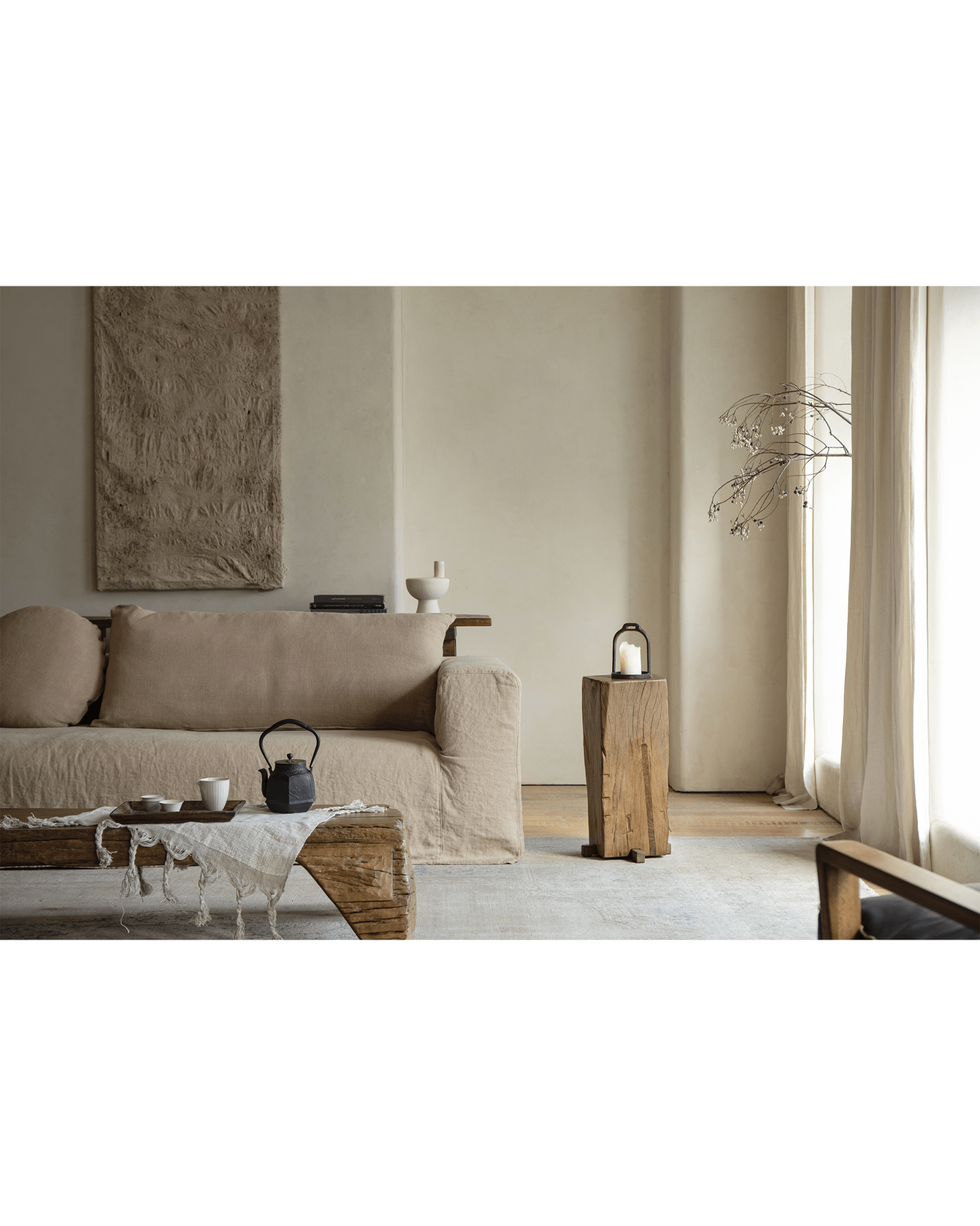 Rustic wooden pedestal side table with candle, organic interior design, aged wood texture