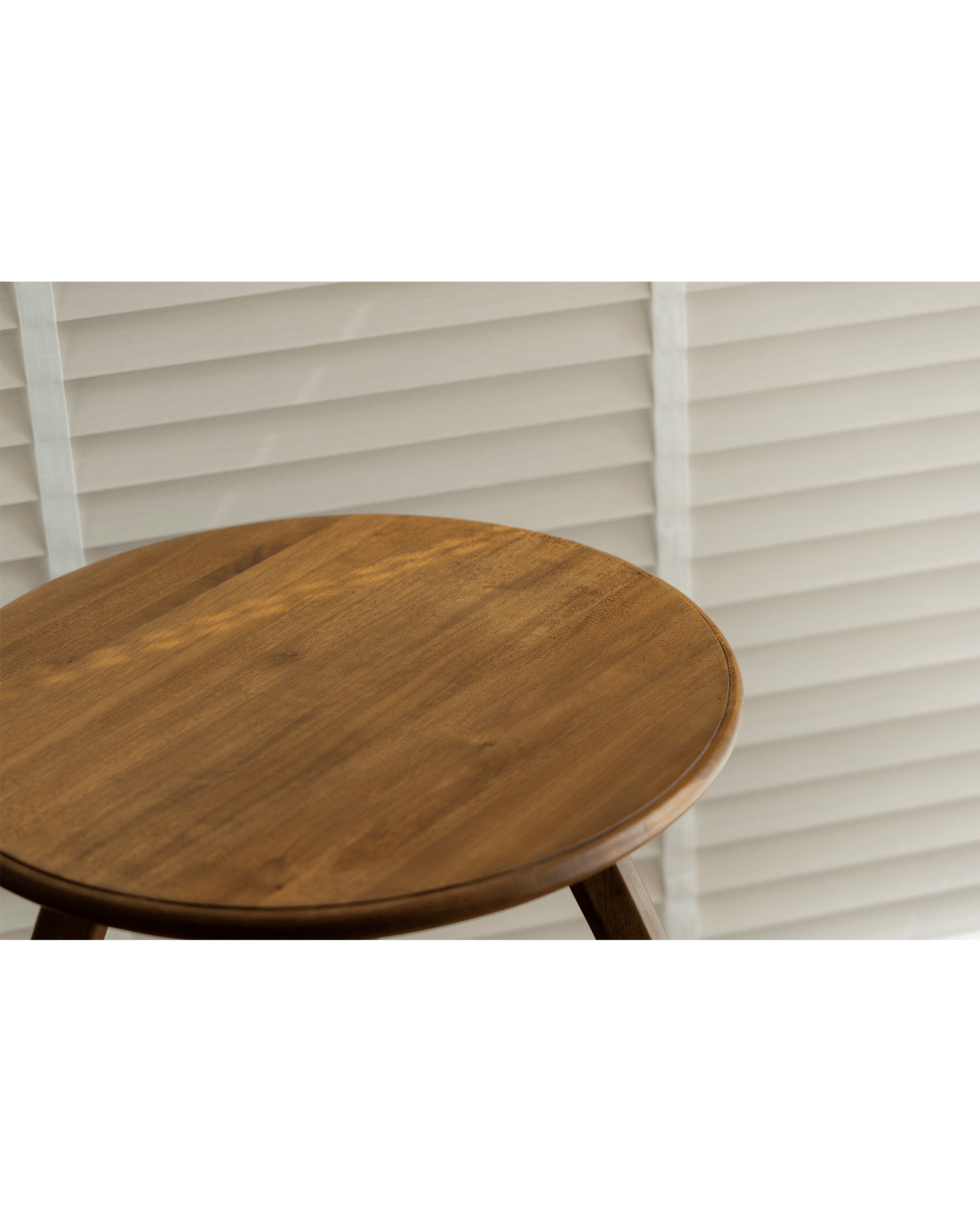 Ele Round Side Table, close-up of Phoebe wood tabletop and leg detail, vintage finish.
