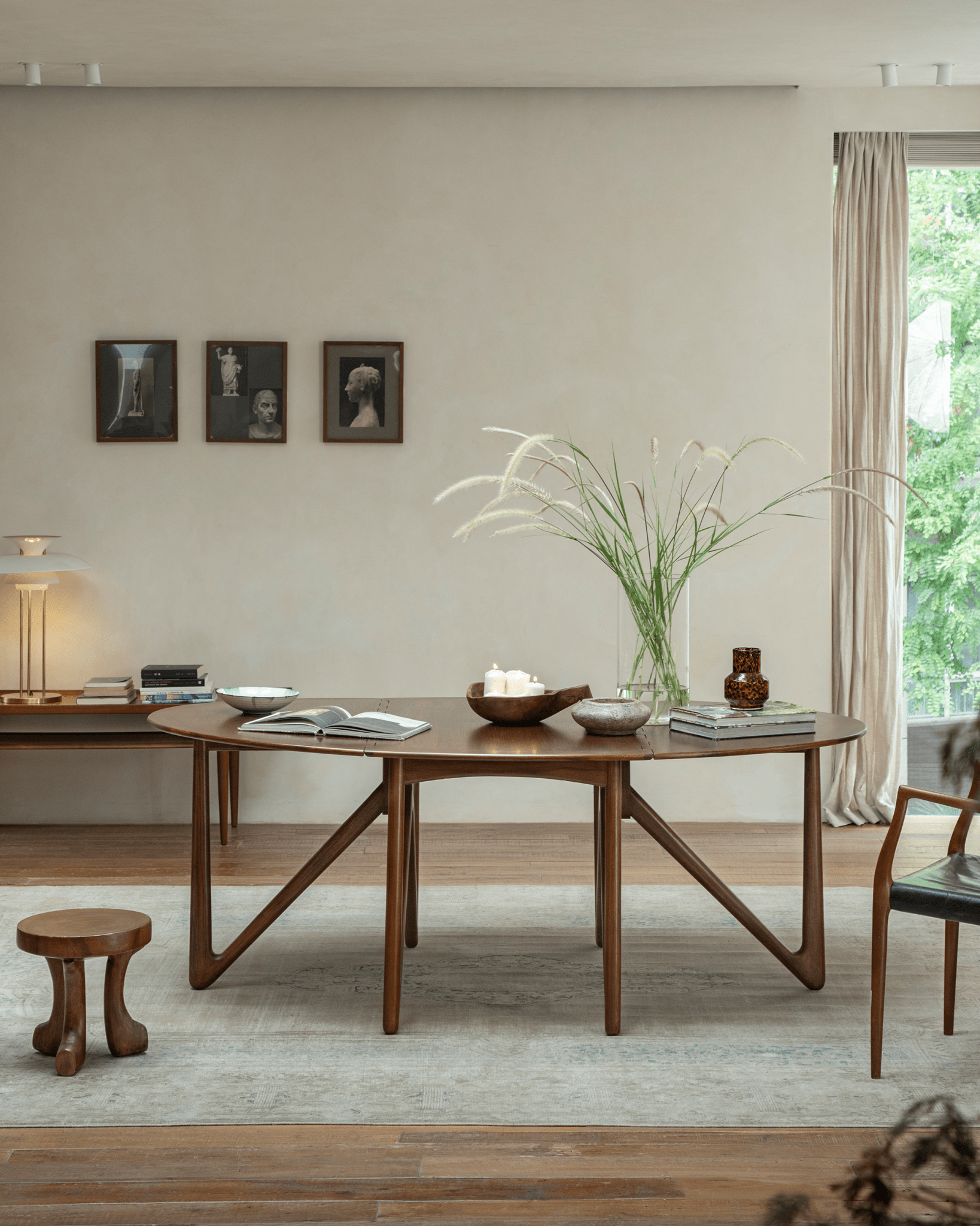 Niels Folding Table in use, mid-century teak wood dining table with V-shaped legs and decor