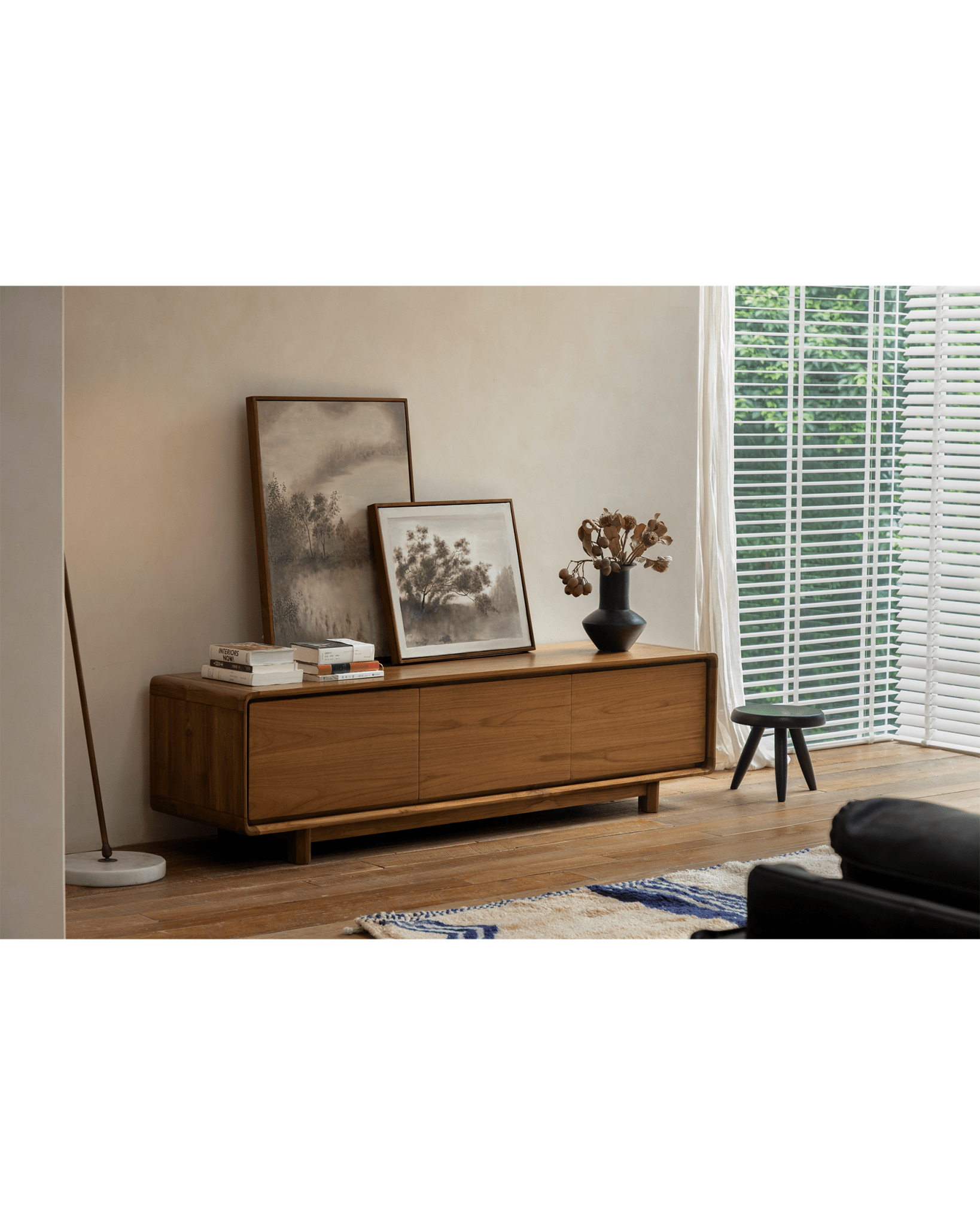 NO.34 Media Console in a modern living room setting, wooden cabinet with decor, artwork, and natural wood finish.