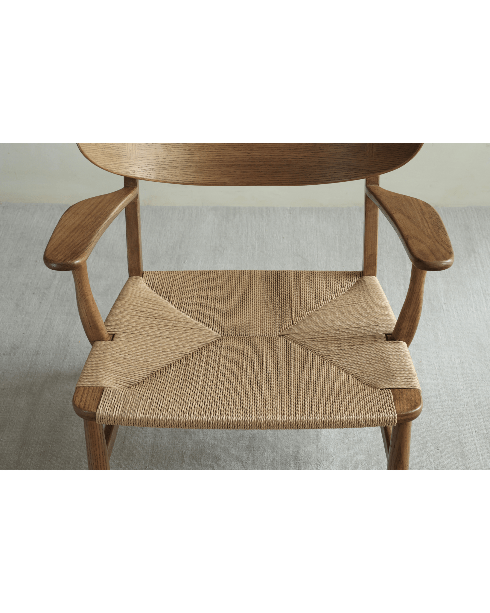 CH22 Lounge Chair detail. Oak frame and handwoven paper cord seat. Danish design and ergonomic comfort.