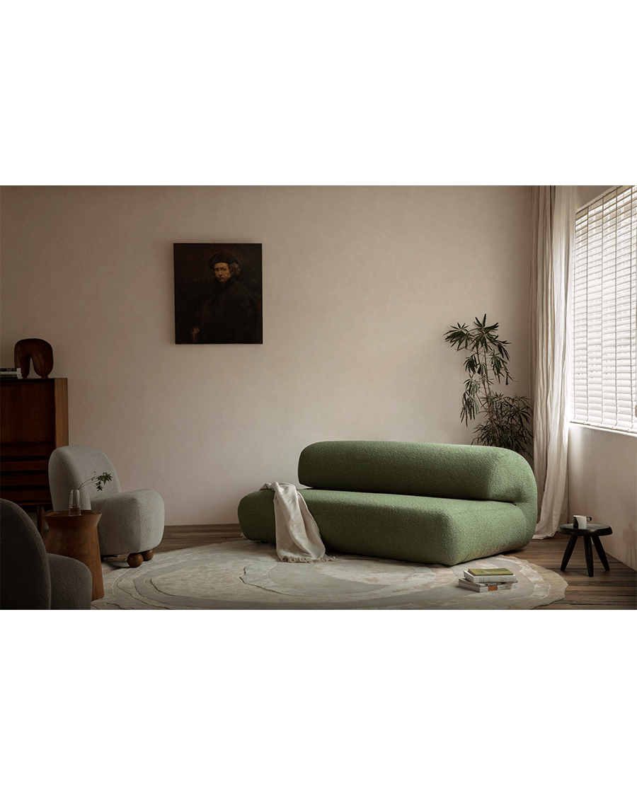 Green Wave Bouclé Sofa in stylish living room setting. Bouclé fabric and wave design.