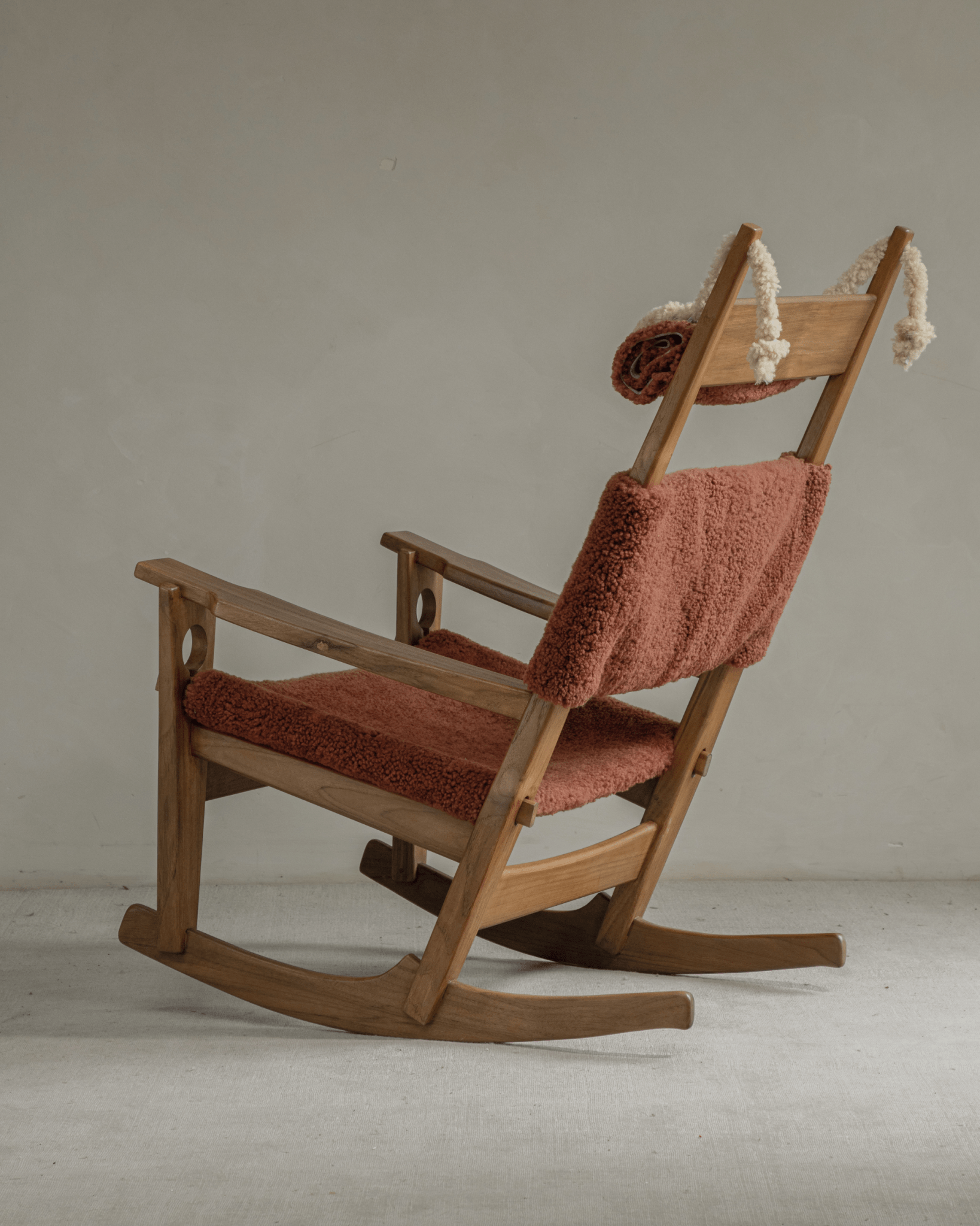 Hans rocking chair - Wine Red Shearling Edition with teak frame and sleigh rockers.