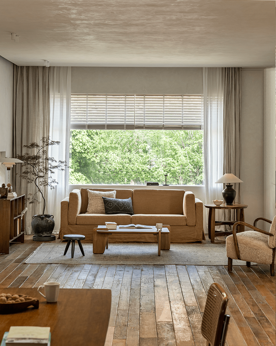 Skirt Linen Sofa in a cozy living room setting, with wooden furniture and neutral tones. Creating a peaceful atmosphere.