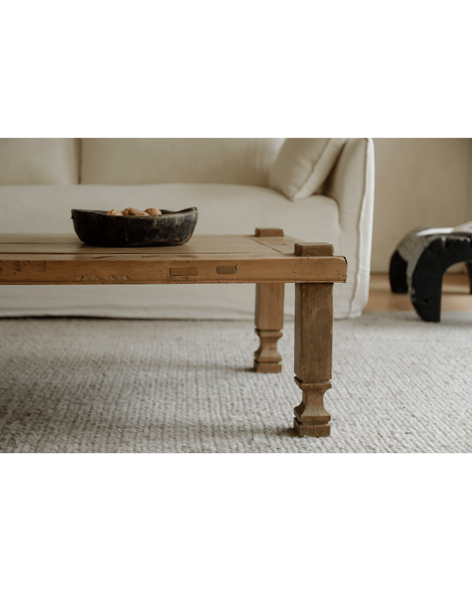 Keoni Coffee Table in natural living room, reclaimed wood with rustic design and simple aesthetic, with a bowl of nuts.