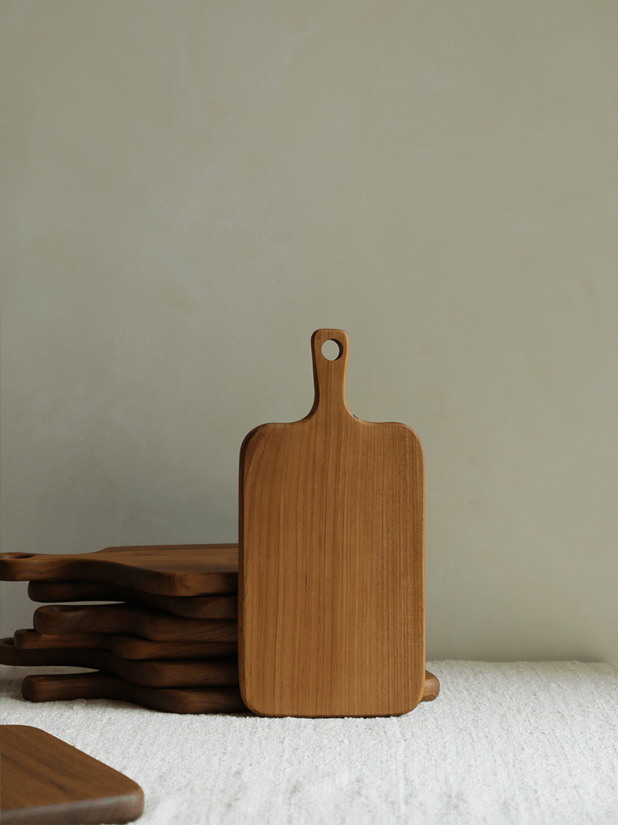 Wooden cutting board stack, natural wood grain, kitchenware.
