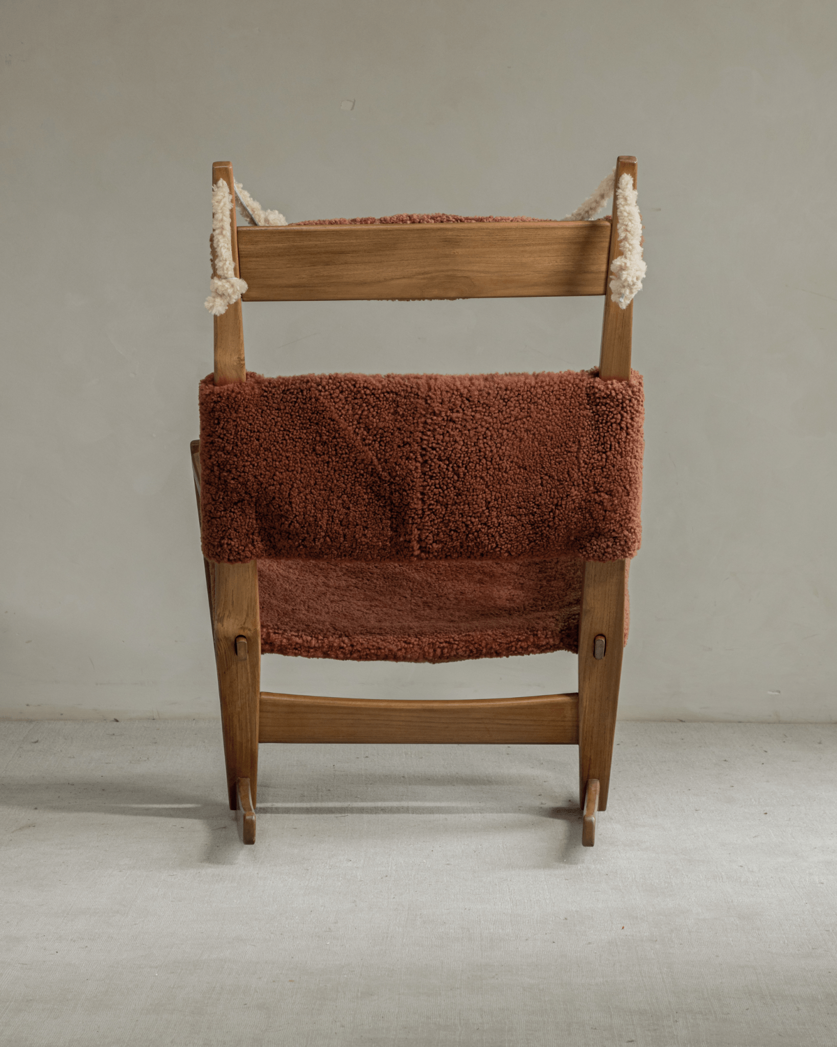 Hans Rocking Chair: Caramel shearling upholstery, solid teak frame, and sleigh legs.