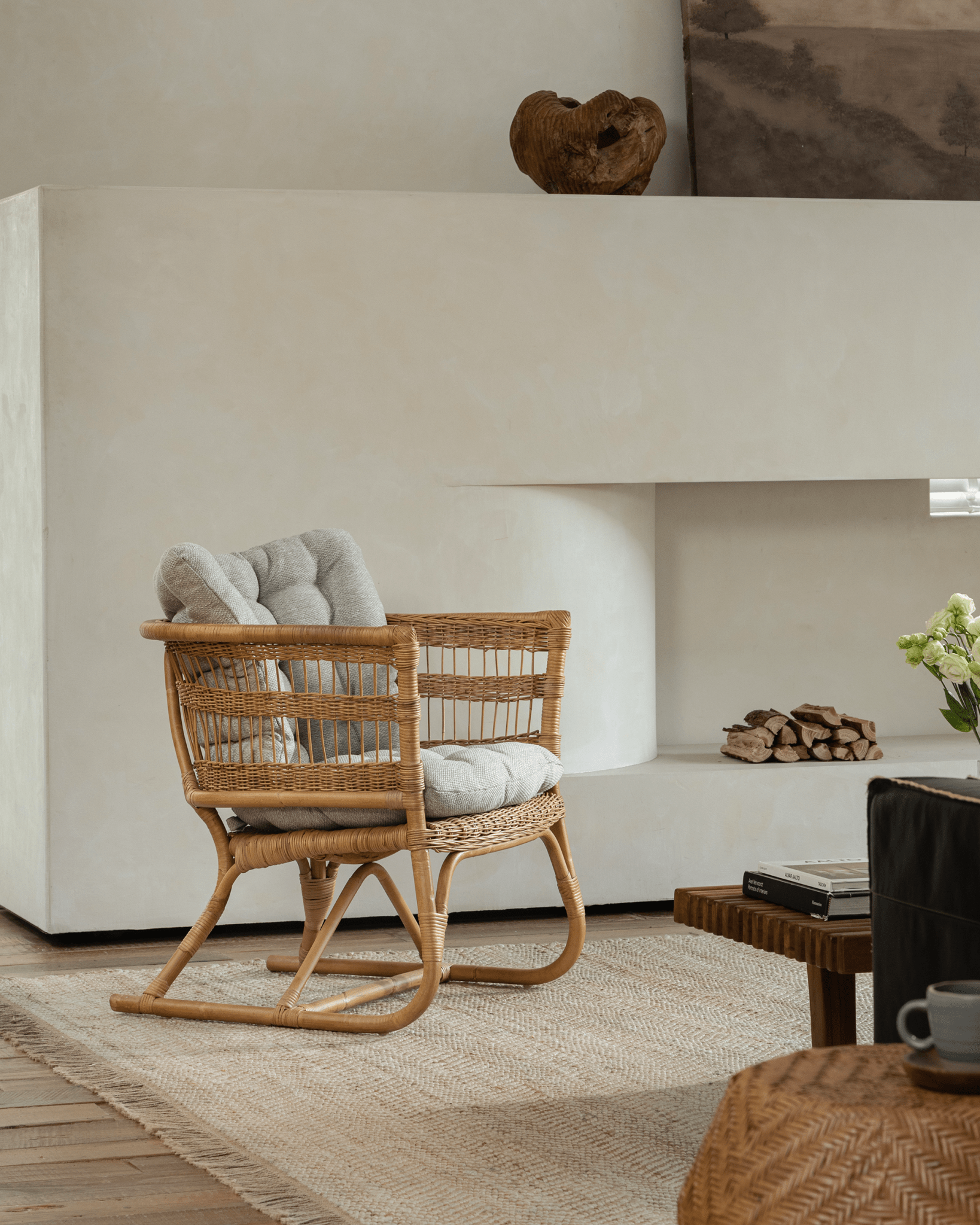 Helian Rattan Chair with gray silk cushion and natural frame, stylish cozy interior