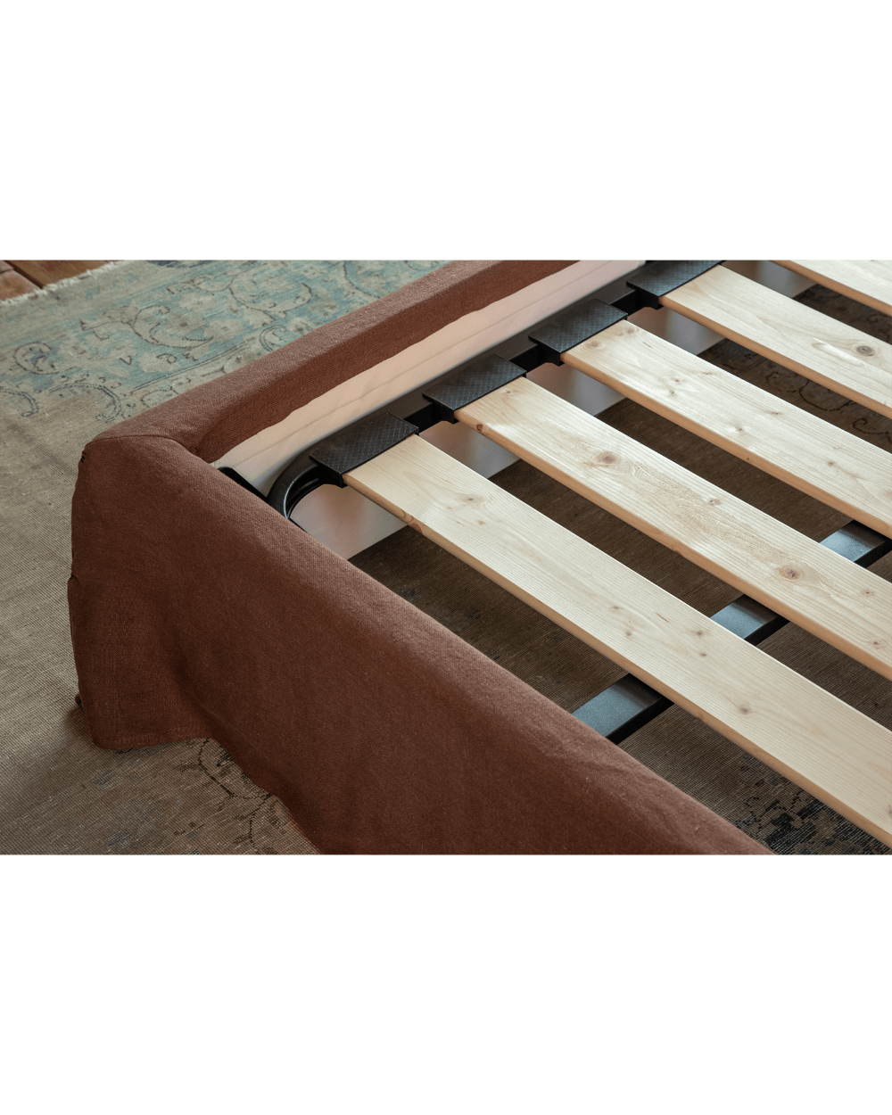 Freya Linen Bed frame detail, showcasing terracotta linen upholstery and solid pine frame.