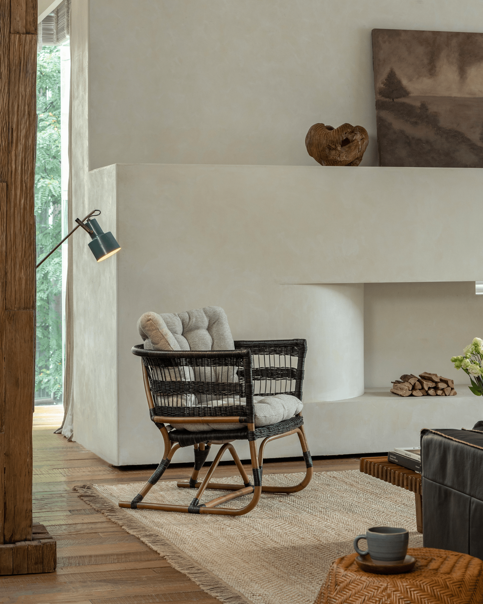 Helian Rattan Chair in a cozy interior setting with black frame and gray cushion