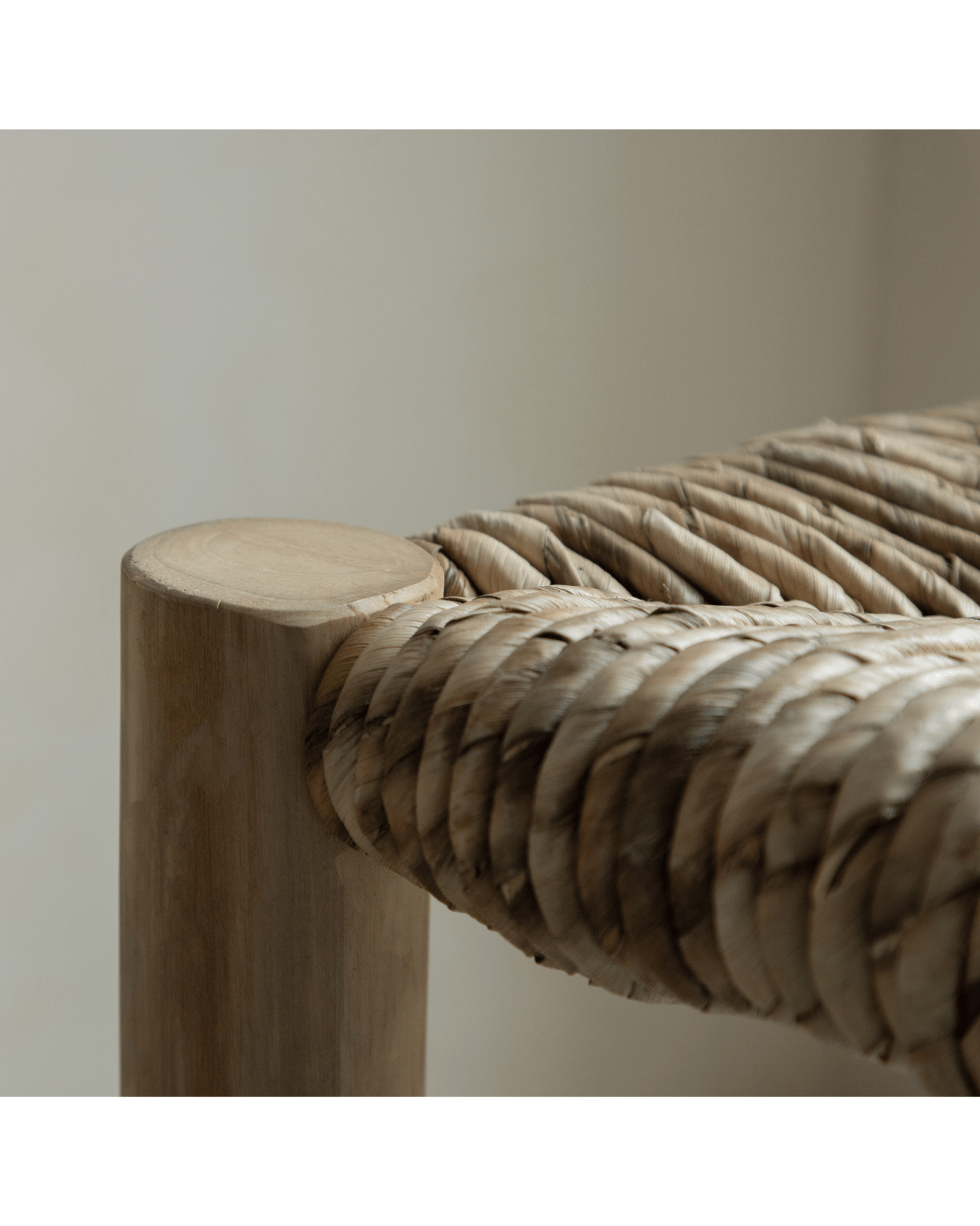Isla Bench close-up: Woven pandan leaf seat and teak leg detail, modern organic design