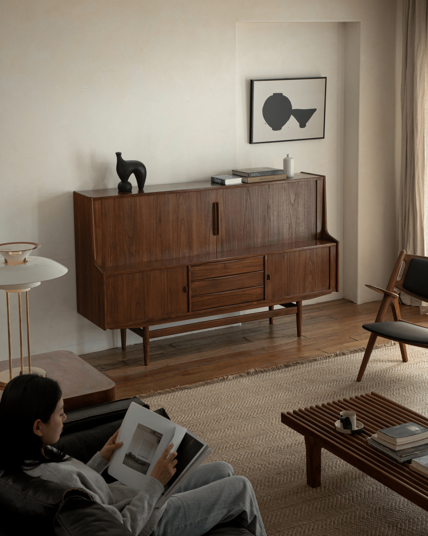 Ibu Teak Sideboard in a modern living room setting with teak wood, Scandinavian design, and tambour doors.