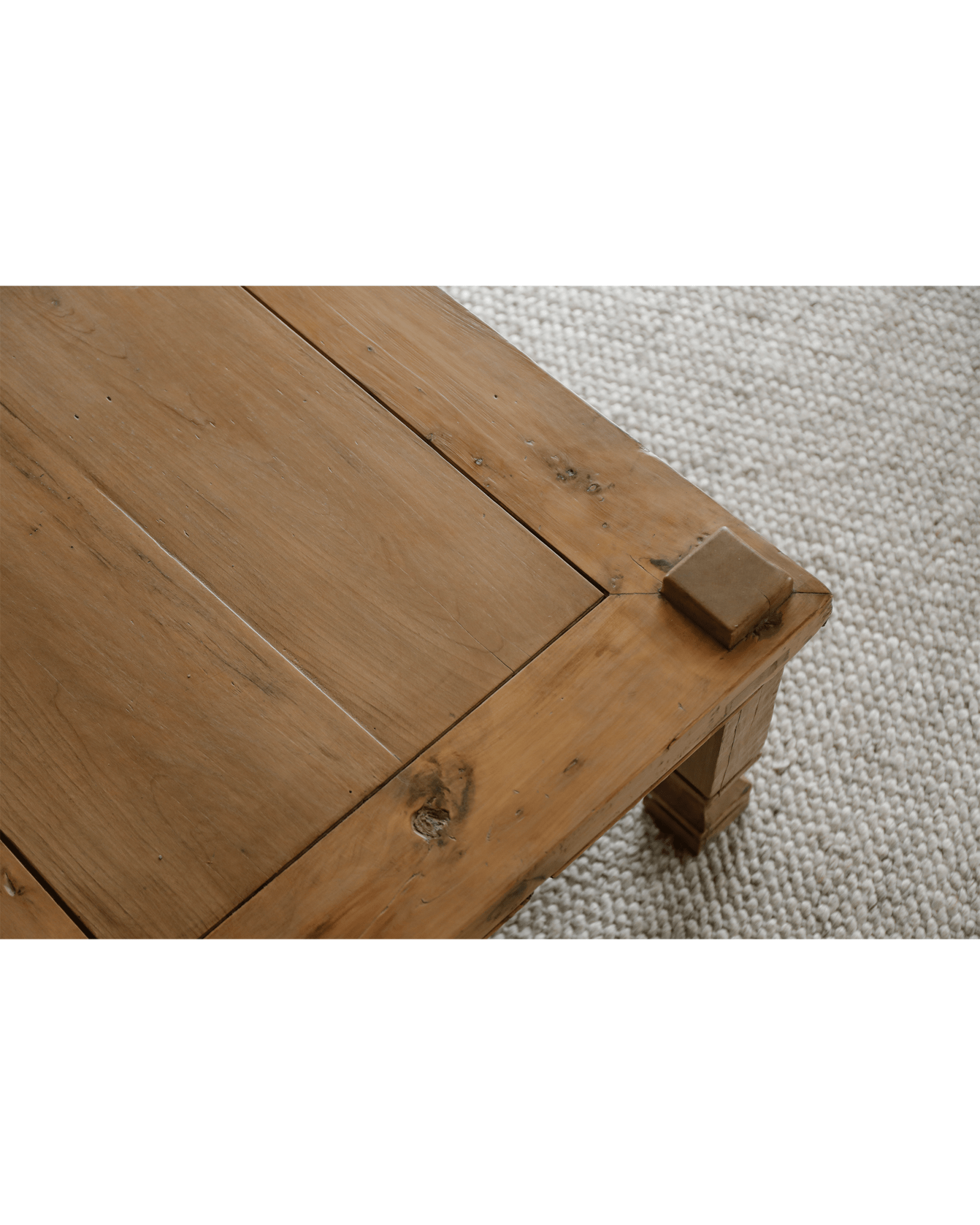 Keoni Coffee Table detail, reclaimed wood with rustic design, natural finish, on off-white rug