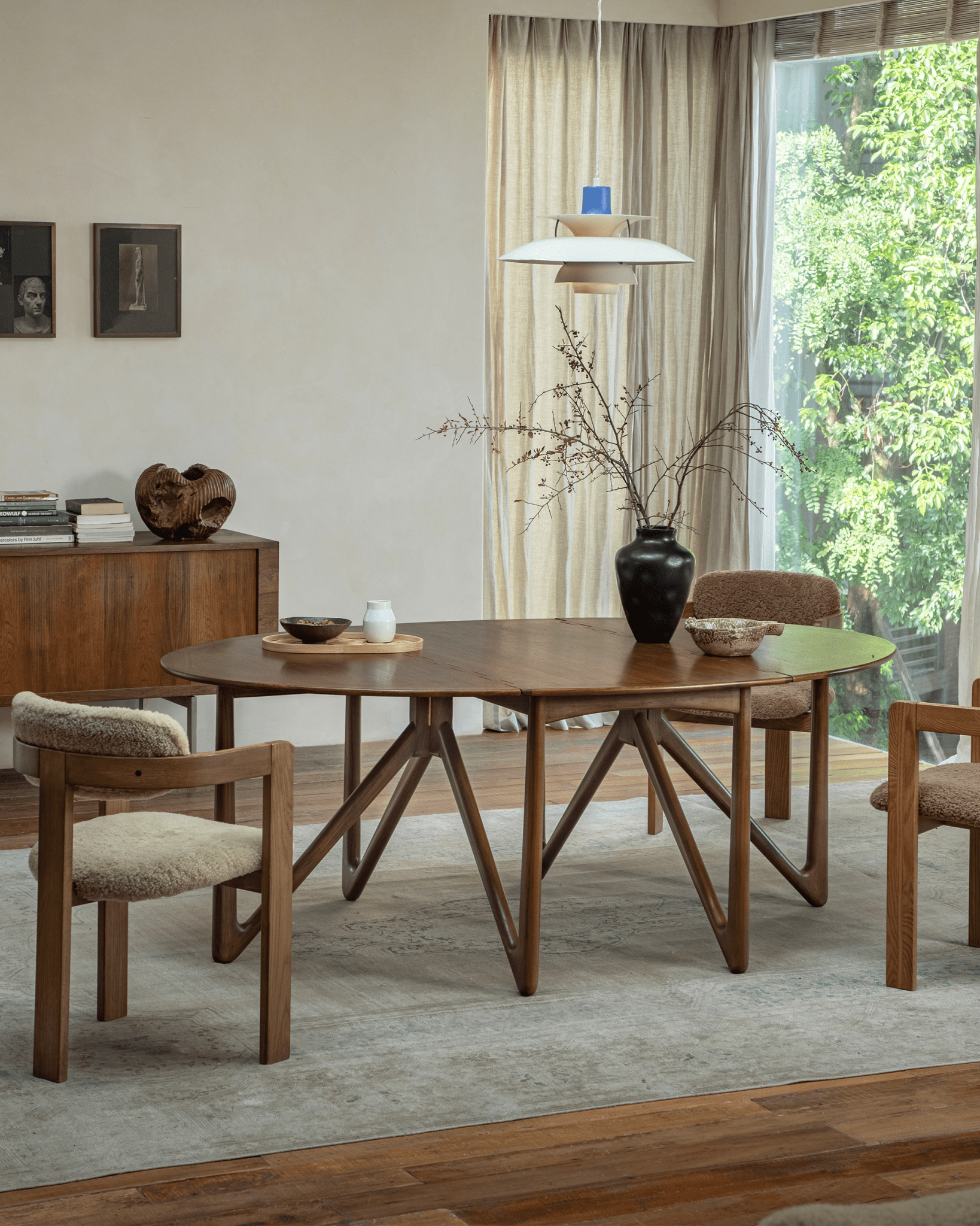 Niels Folding Table extended in dining room setting, Burmese teak wood with V-shaped legs, mid-century modern design