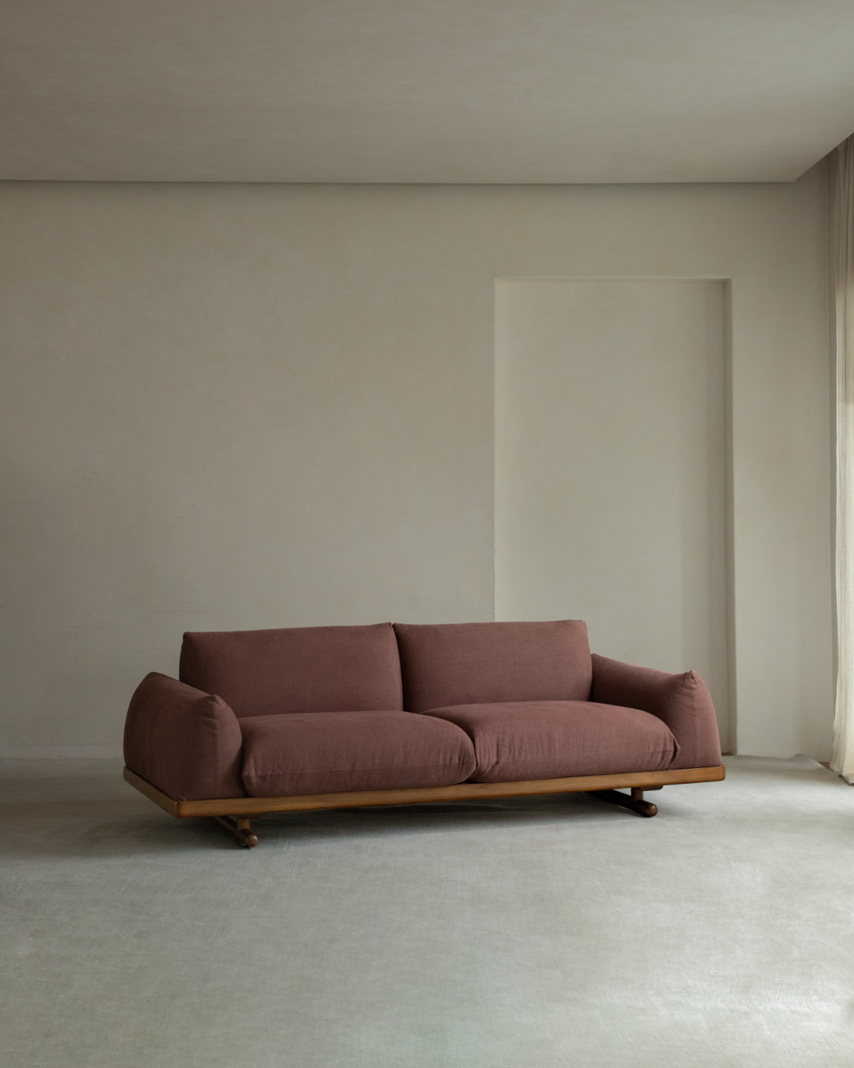 Adrian Sofa with mauve linen upholstery and teak wood base in minimalist room